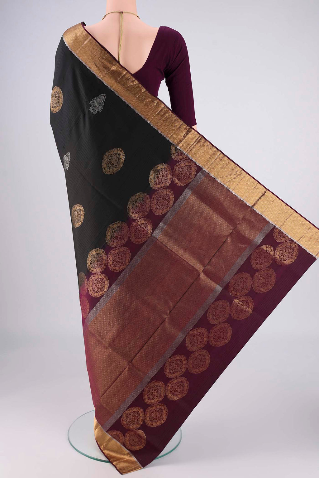 Flat view of Black Soft Silk Saree with Zari Butta on the body and Zari Border. 
