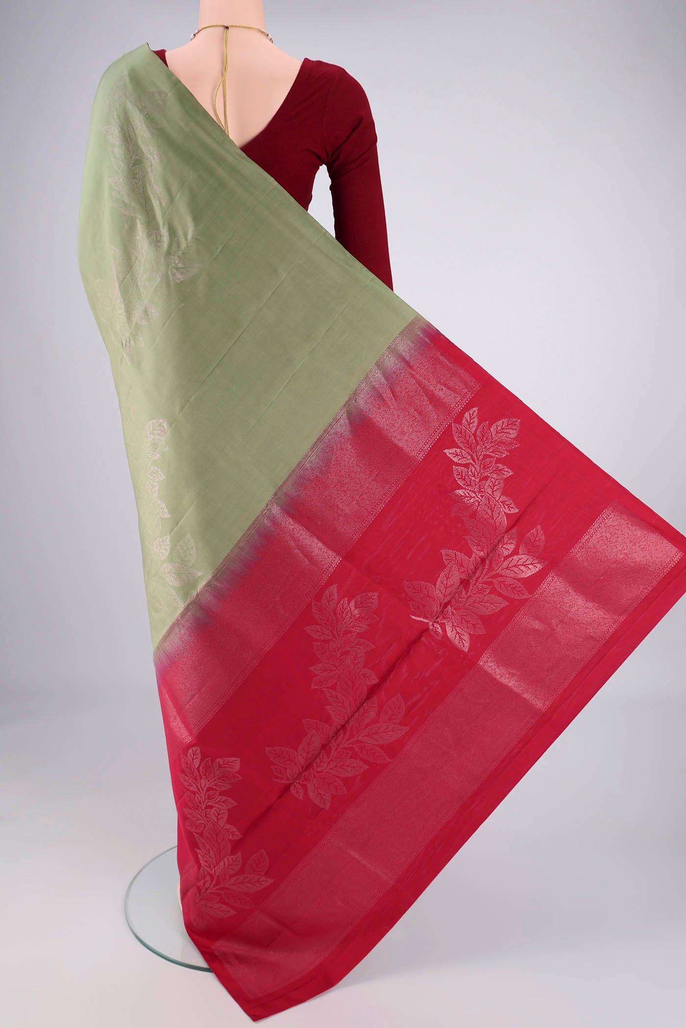 Flat view of Sage Green Soft Silk Saree with Zari Butta on the body and Without Border. 