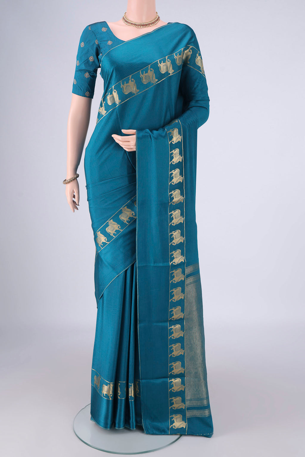 Teal Mysore Crepe Saree with Plain Body and Zari Border.  displayed on a mannequin