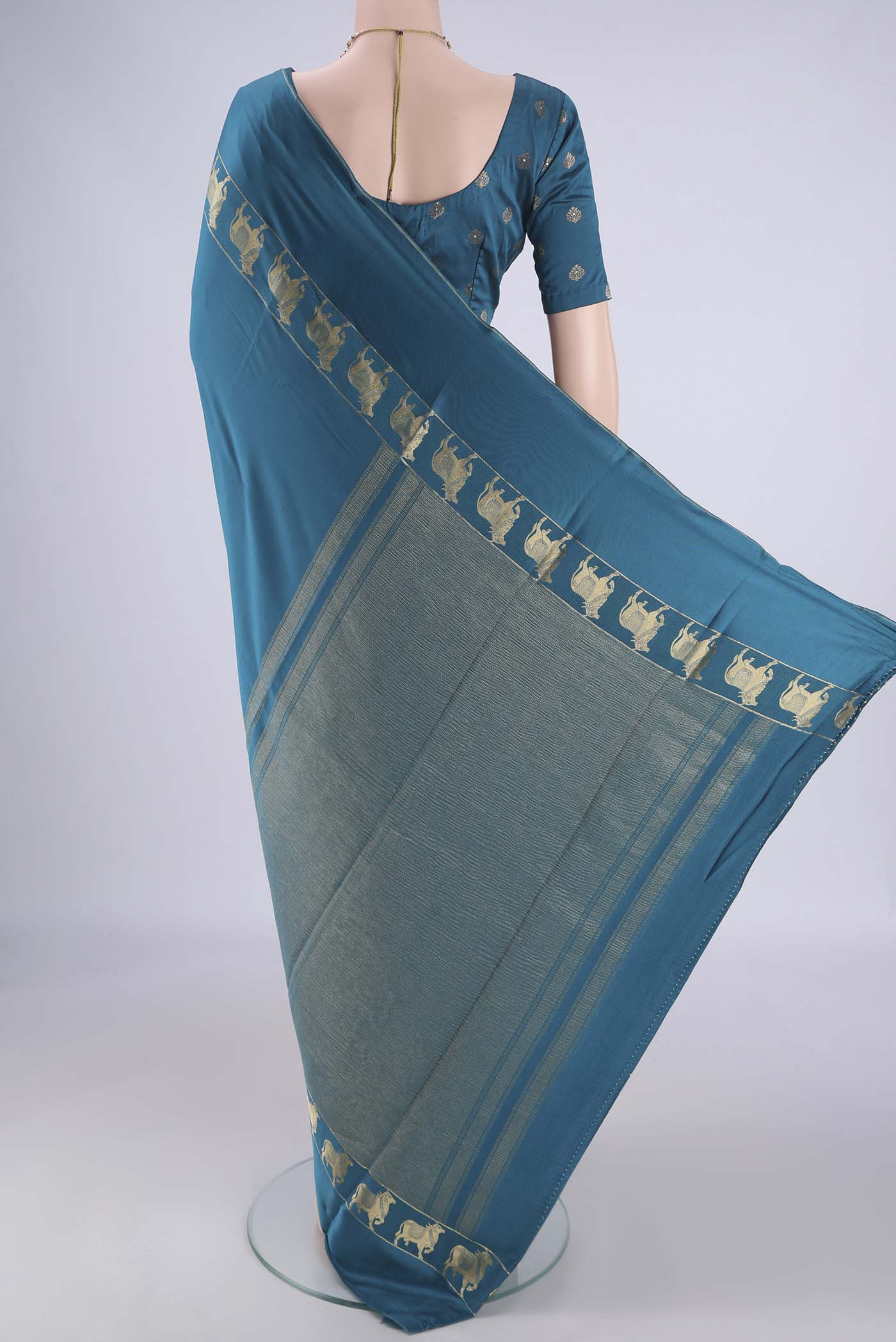 Flat view of Teal Mysore Crepe Saree with Plain Body and Zari Border. 