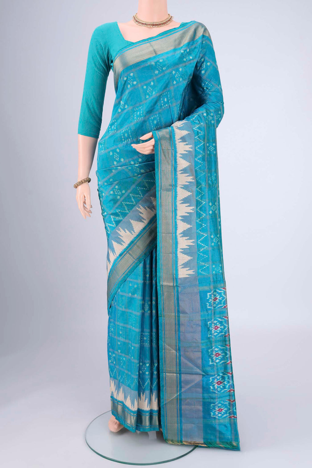 Turquoise Pochampally Silk Saree with Checked design on the body and Zari Border.  displayed on a mannequin
