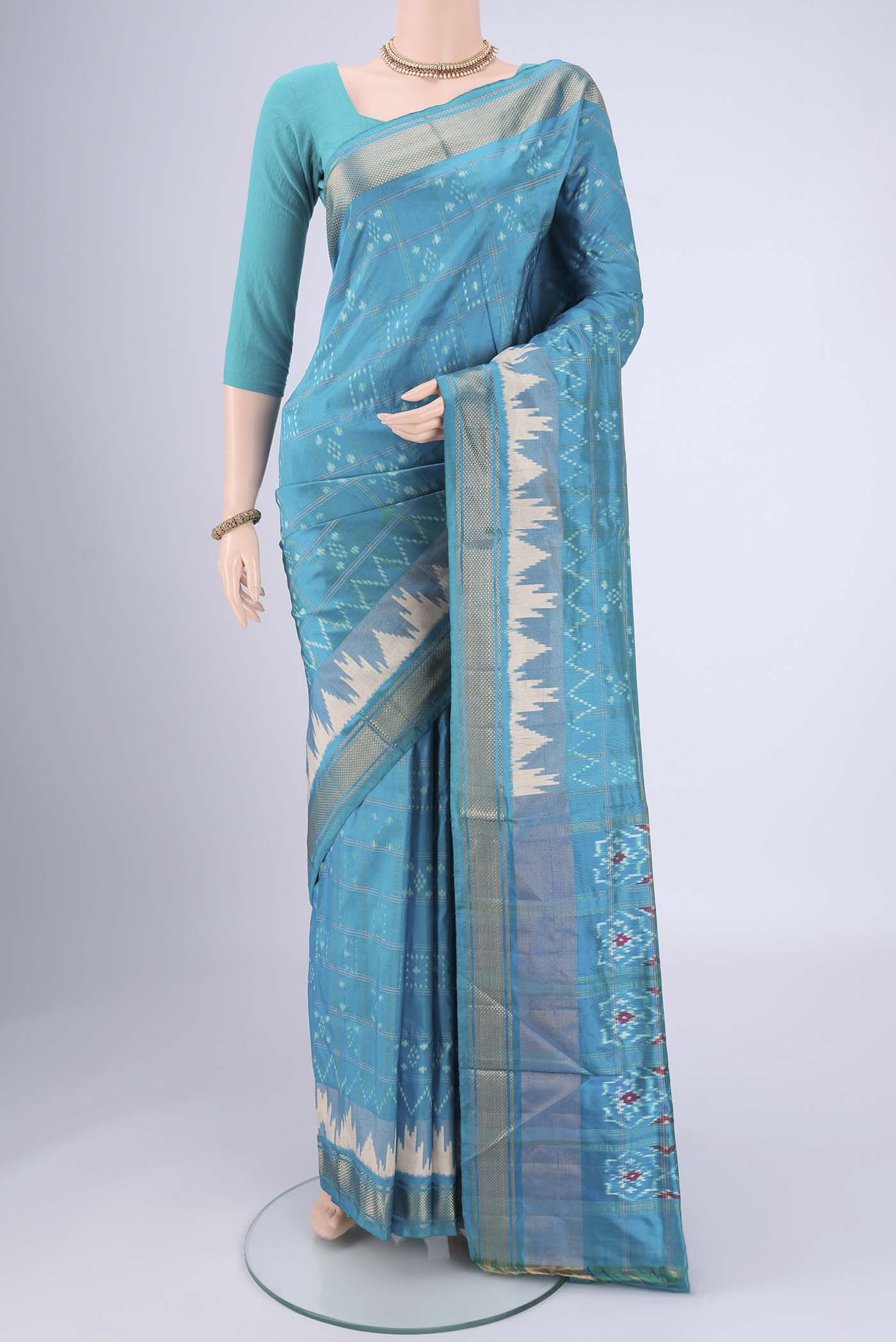 Turquoise Pochampally Silk Saree with Checked design on the body and Zari Border.  displayed on a mannequin