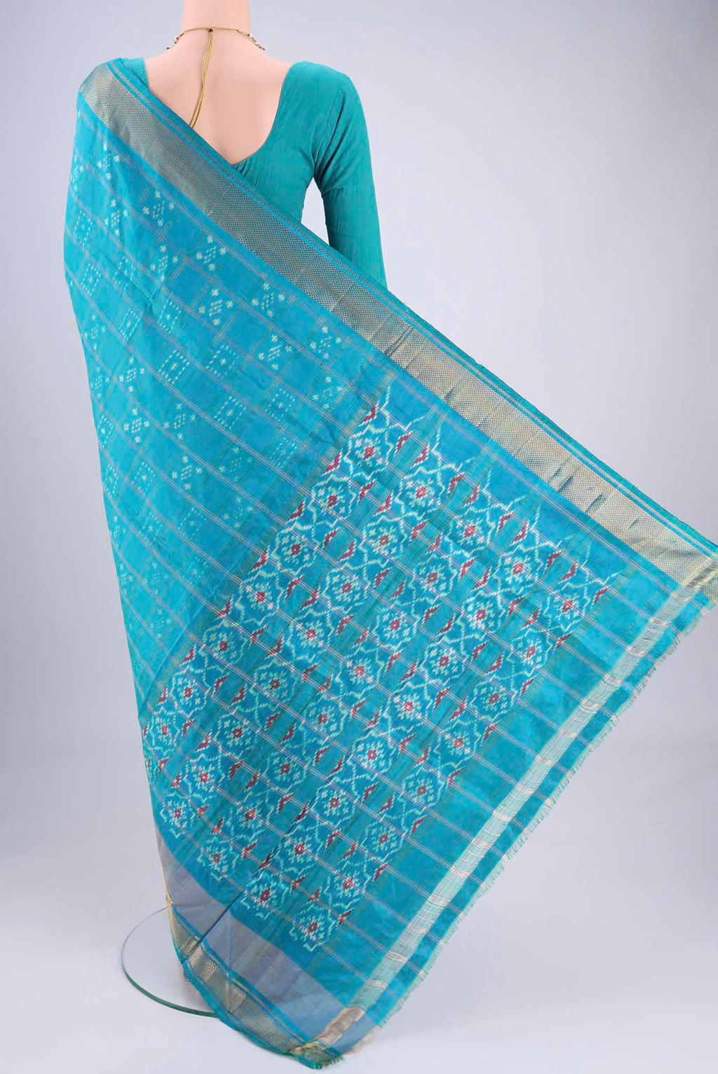 Flat view of Turquoise Pochampally Silk Saree with Checked design on the body and Zari Border. 