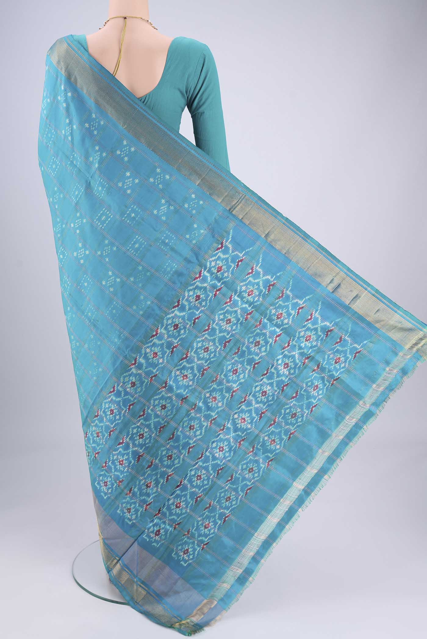 Flat view of Turquoise Pochampally Silk Saree with Checked design on the body and Zari Border. 