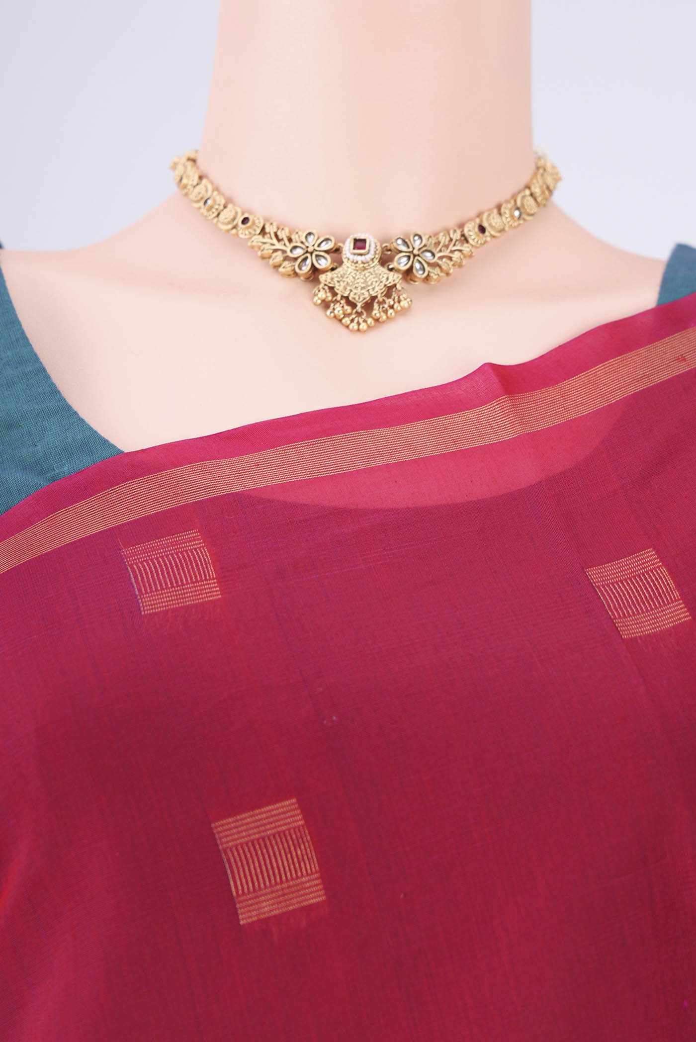 Border image of Red Kora Cotton Saree with Zari Butta on the body and Plain Border. 