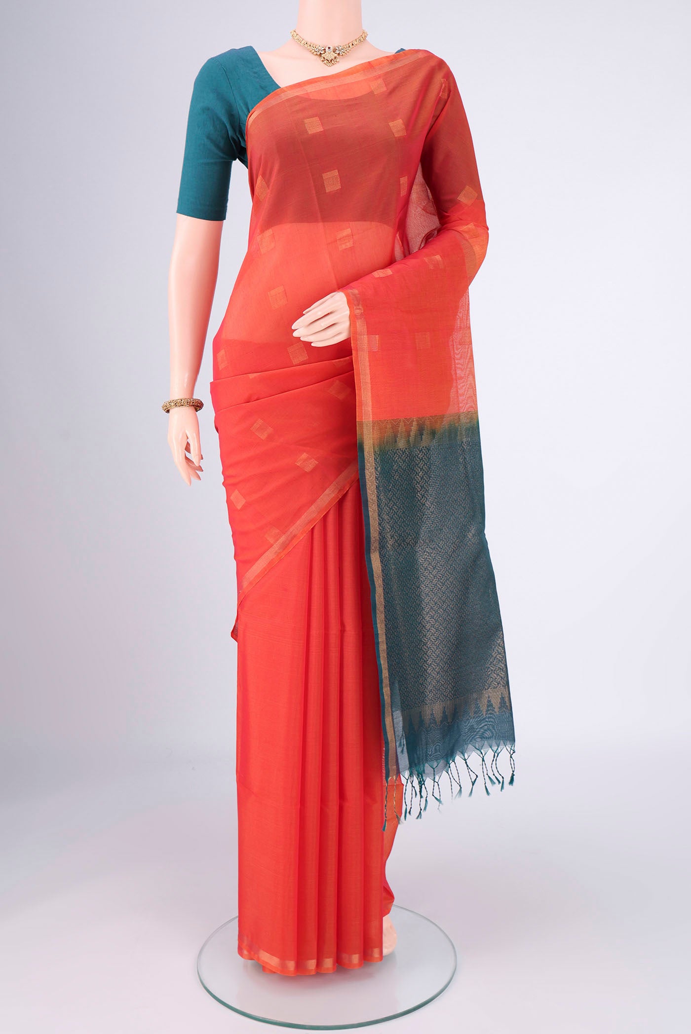 Orange Kora Cotton Saree with Zari Butta on the body and Plain Border.  displayed on a mannequin