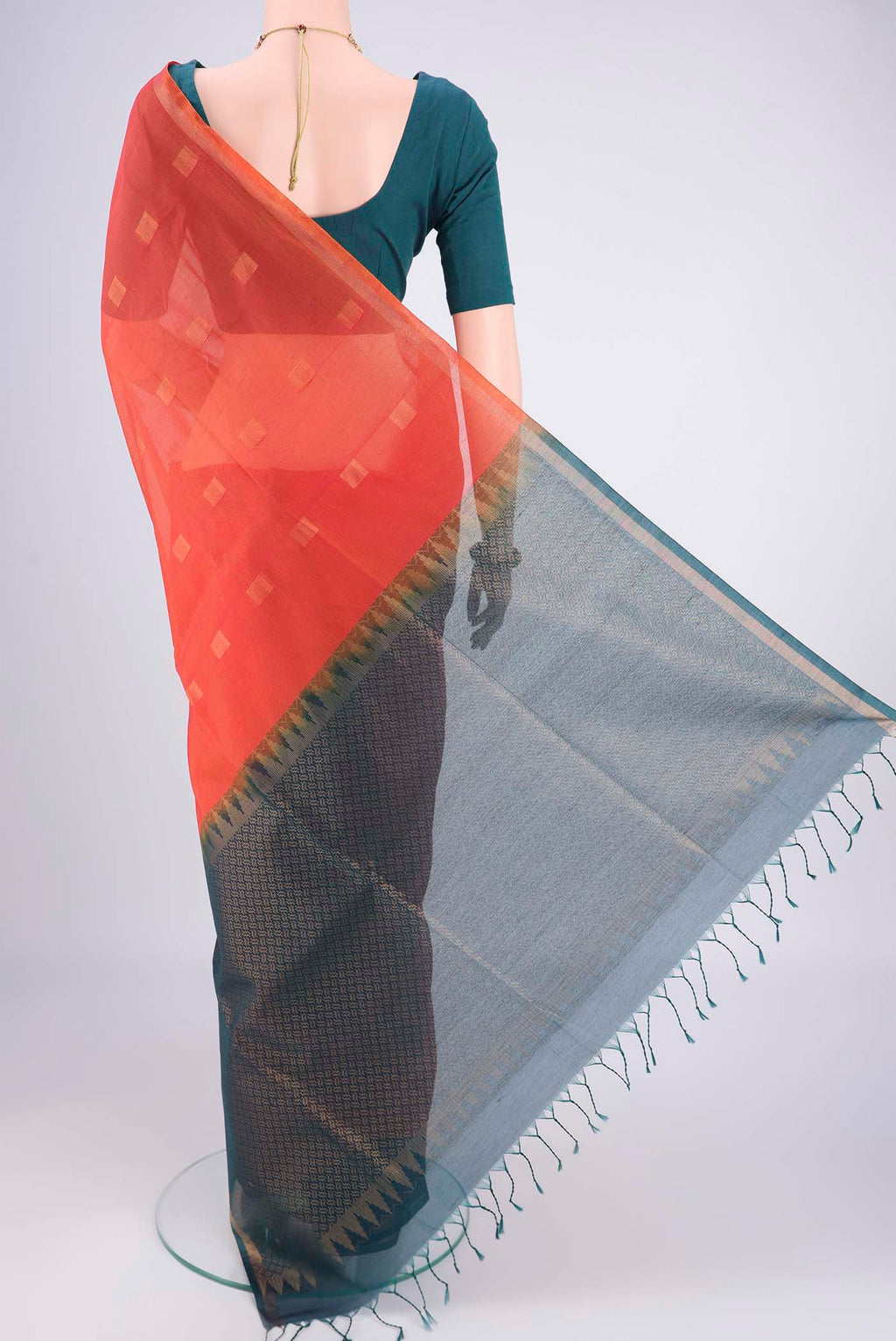 Flat view of Orange Kora Cotton Saree with Zari Butta on the body and Plain Border. 