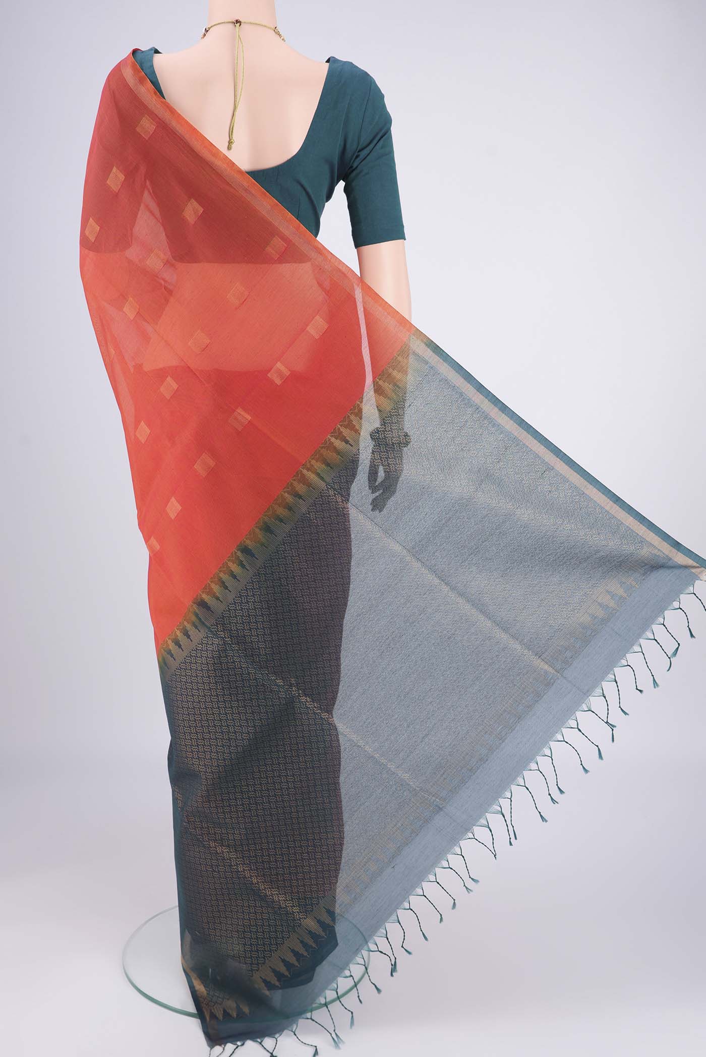 Flat view of Orange Kora Cotton Saree with Zari Butta on the body and Plain Border. 
