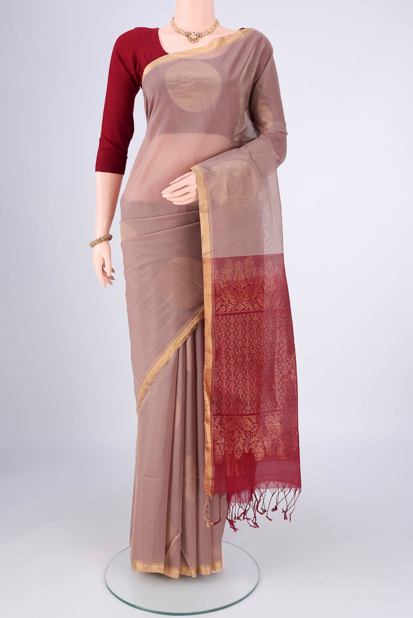 Dark Beige Kora Cotton Saree with Zari Butta on the body and Plain Border.  displayed on a mannequin