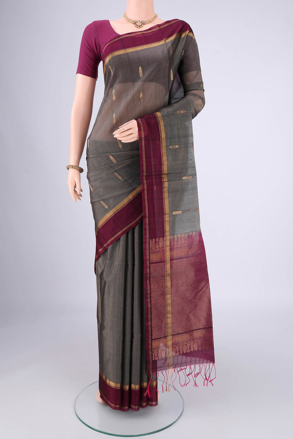 Grey Silk Cotton Saree with Zari Brocade on the body and Zari Border.  displayed on a mannequin
