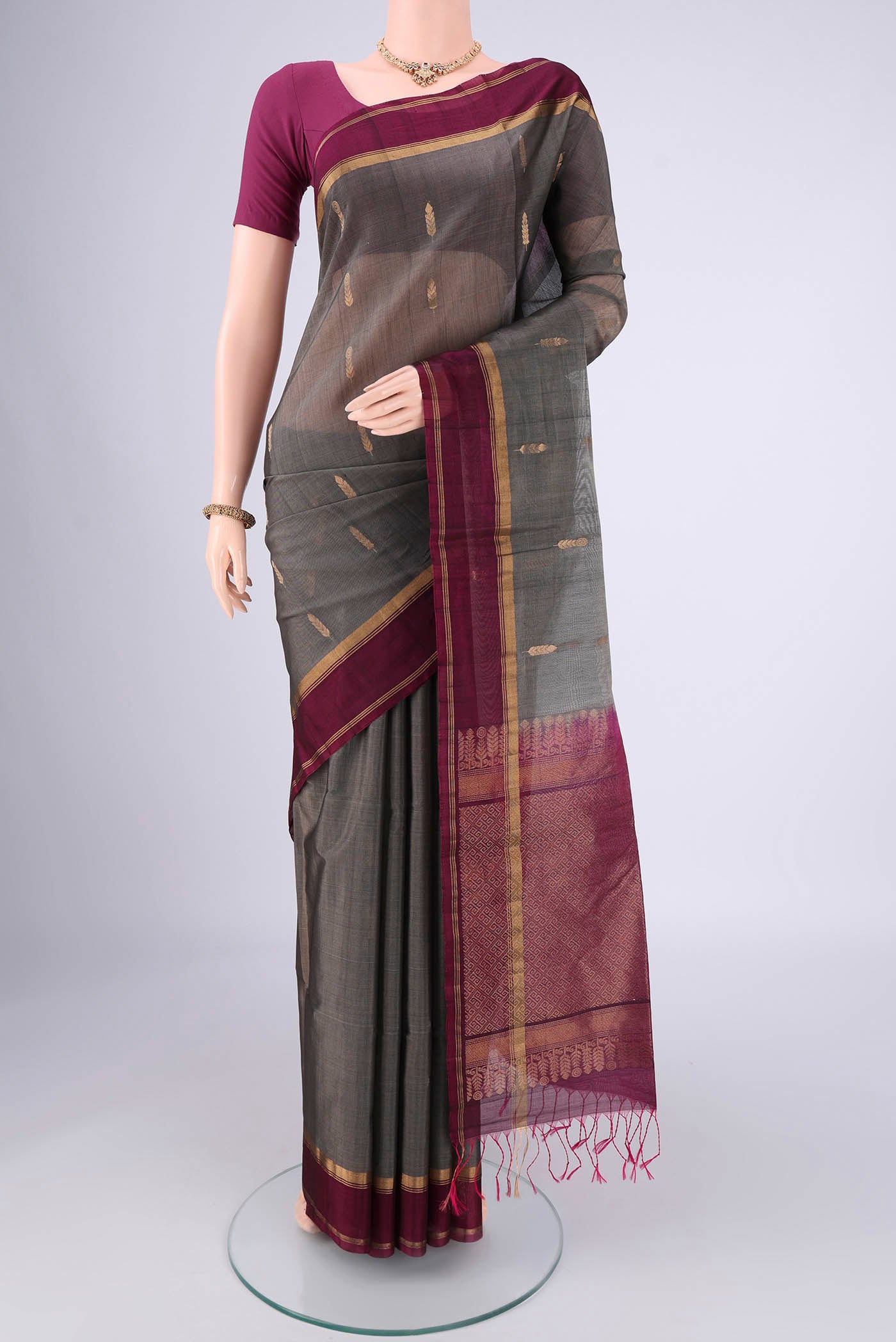 Grey Silk Cotton Saree with Zari Brocade on the body and Zari Border.  displayed on a mannequin