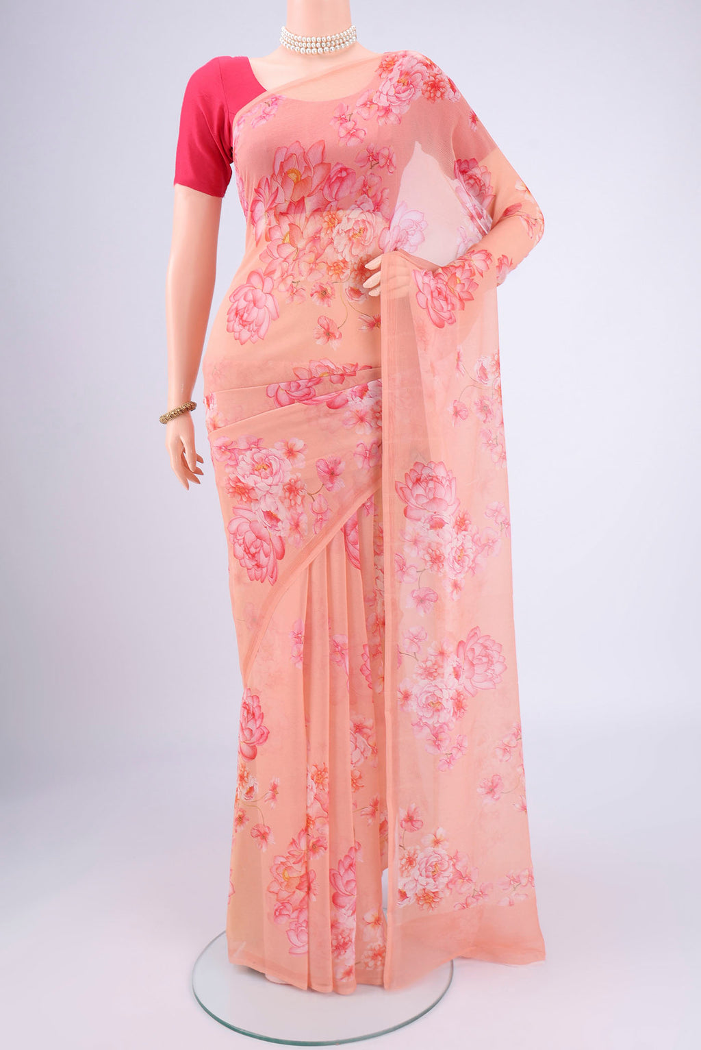 Peach Mysore Chiffon Saree with Floral Print on the body and Plain Border.  displayed on a mannequin