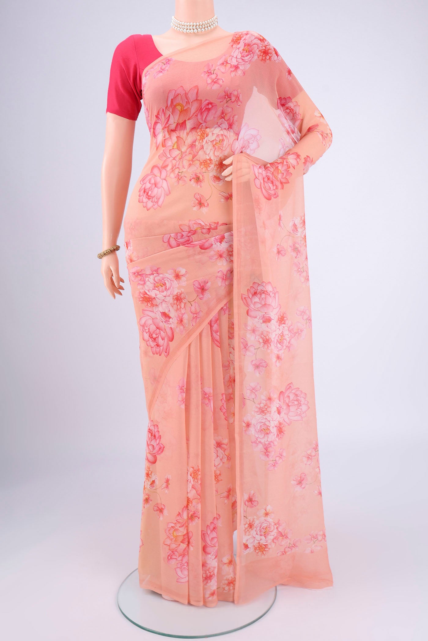 Peach Mysore Chiffon Saree with Floral Print on the body and Plain Border.  displayed on a mannequin