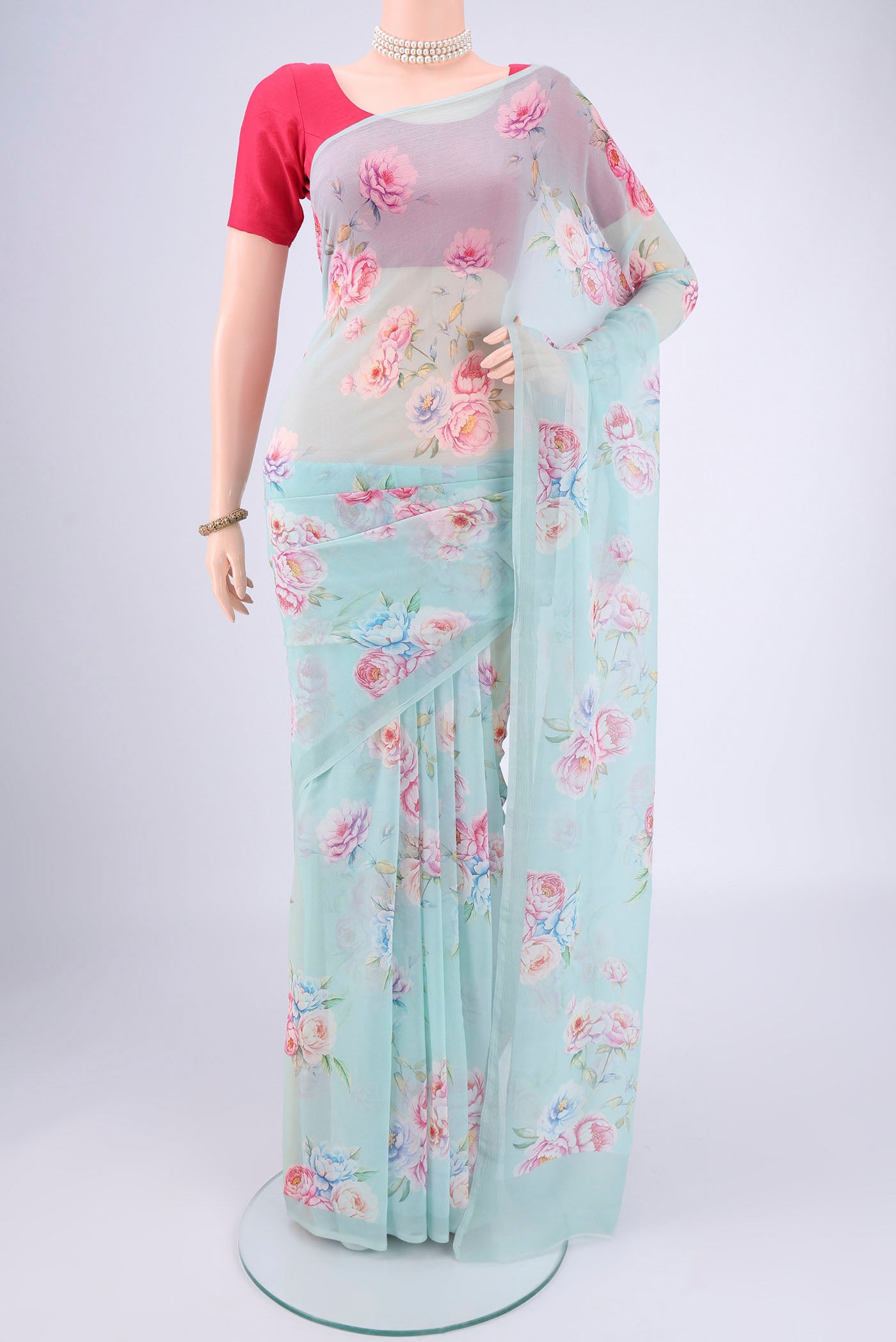 Sky Blue Mysore Chiffon Saree with Floral Print on the body and Plain Border.  displayed on a mannequin