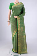 Light Green Kanjivaram Silk Saree with Zari Butta on the body and Zari Border.  displayed on a mannequin