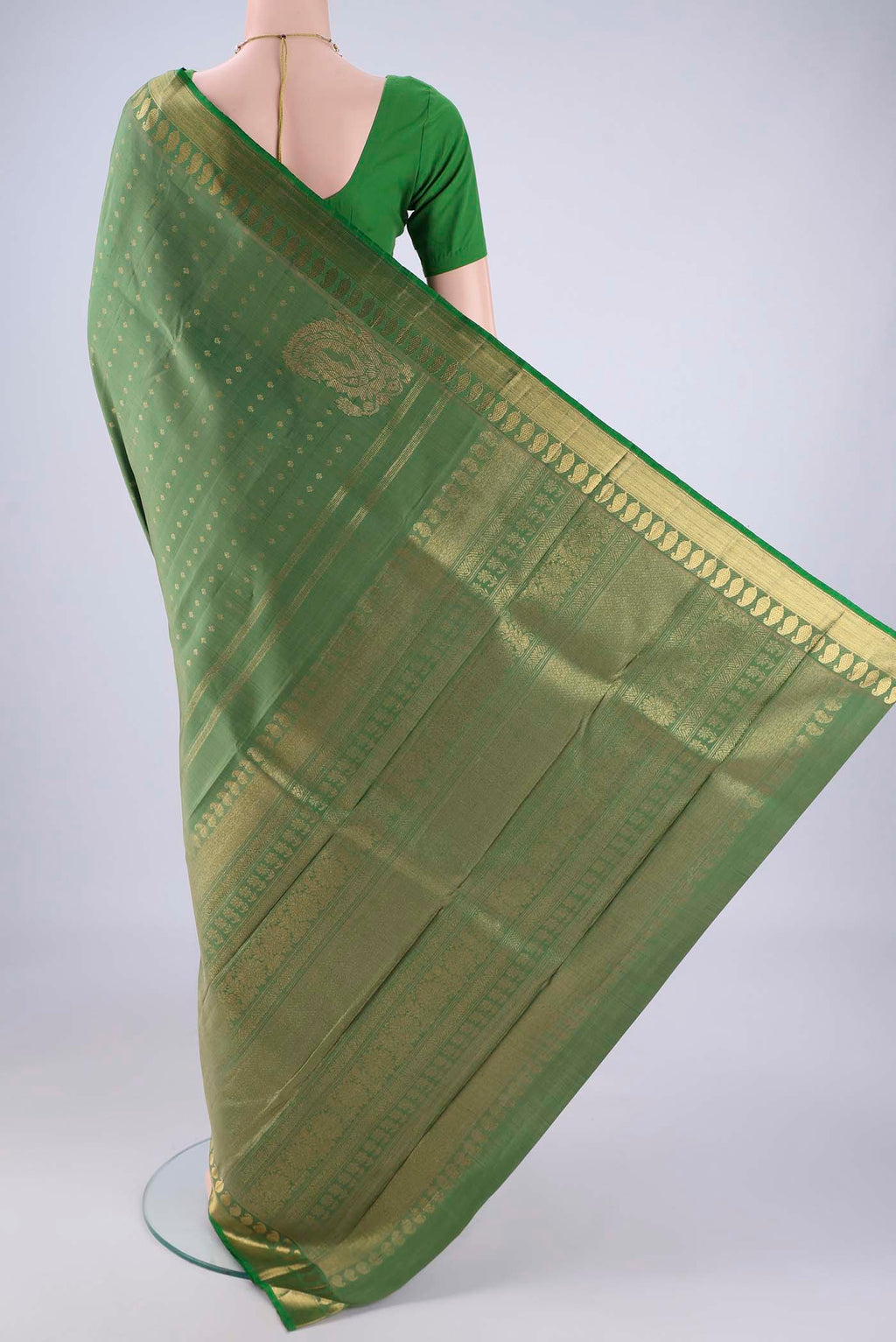 Flat view of Light Green Kanjivaram Silk Saree with Zari Butta on the body and Zari Border. 