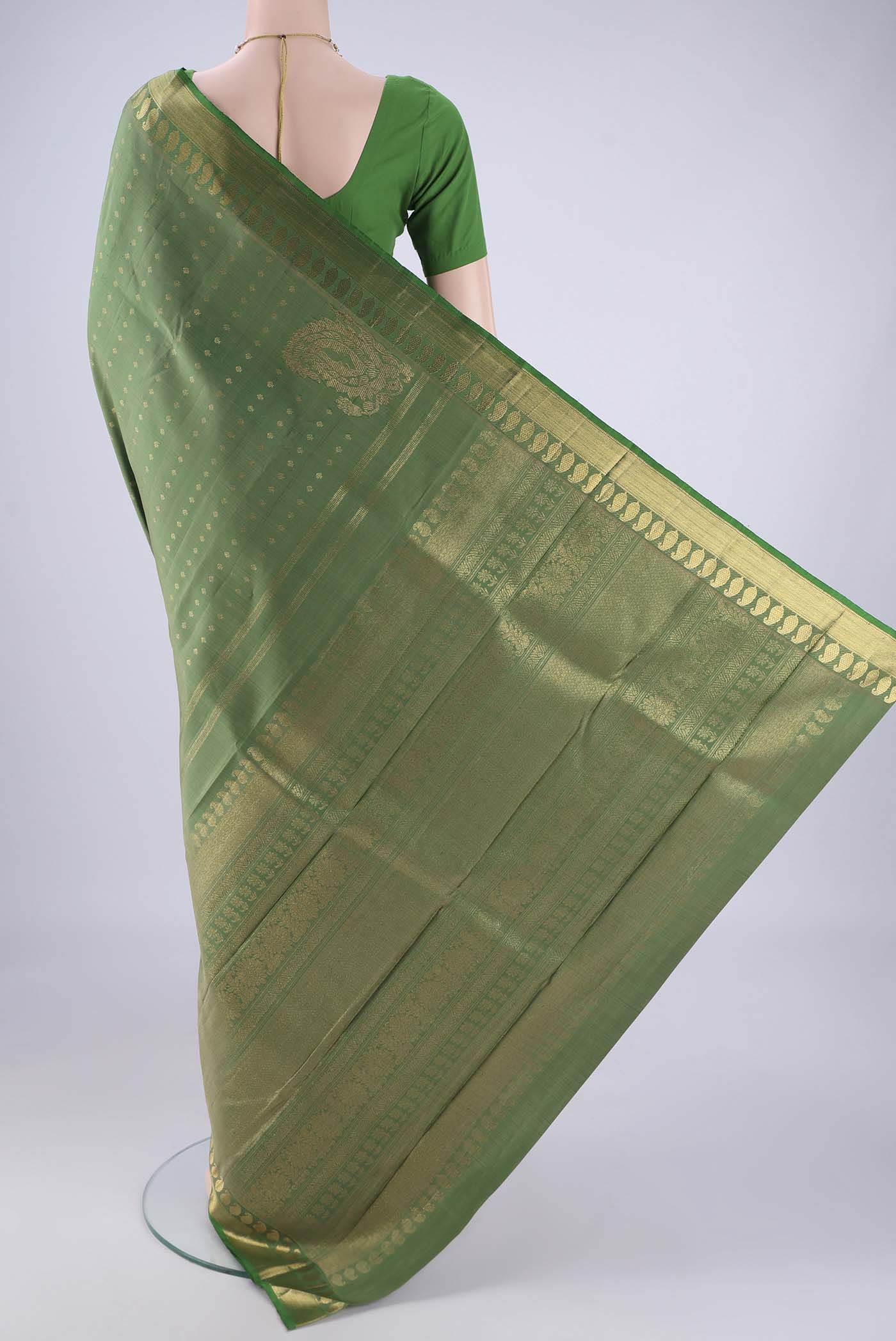 Flat view of Light Green Kanjivaram Silk Saree with Zari Butta on the body and Zari Border. 