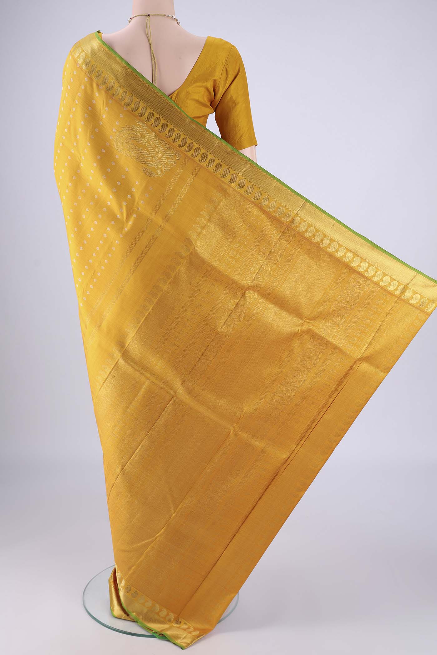 Flat view of Mustard Kanjivaram Silk Saree with Zari Butta on the body and Zari Border. 