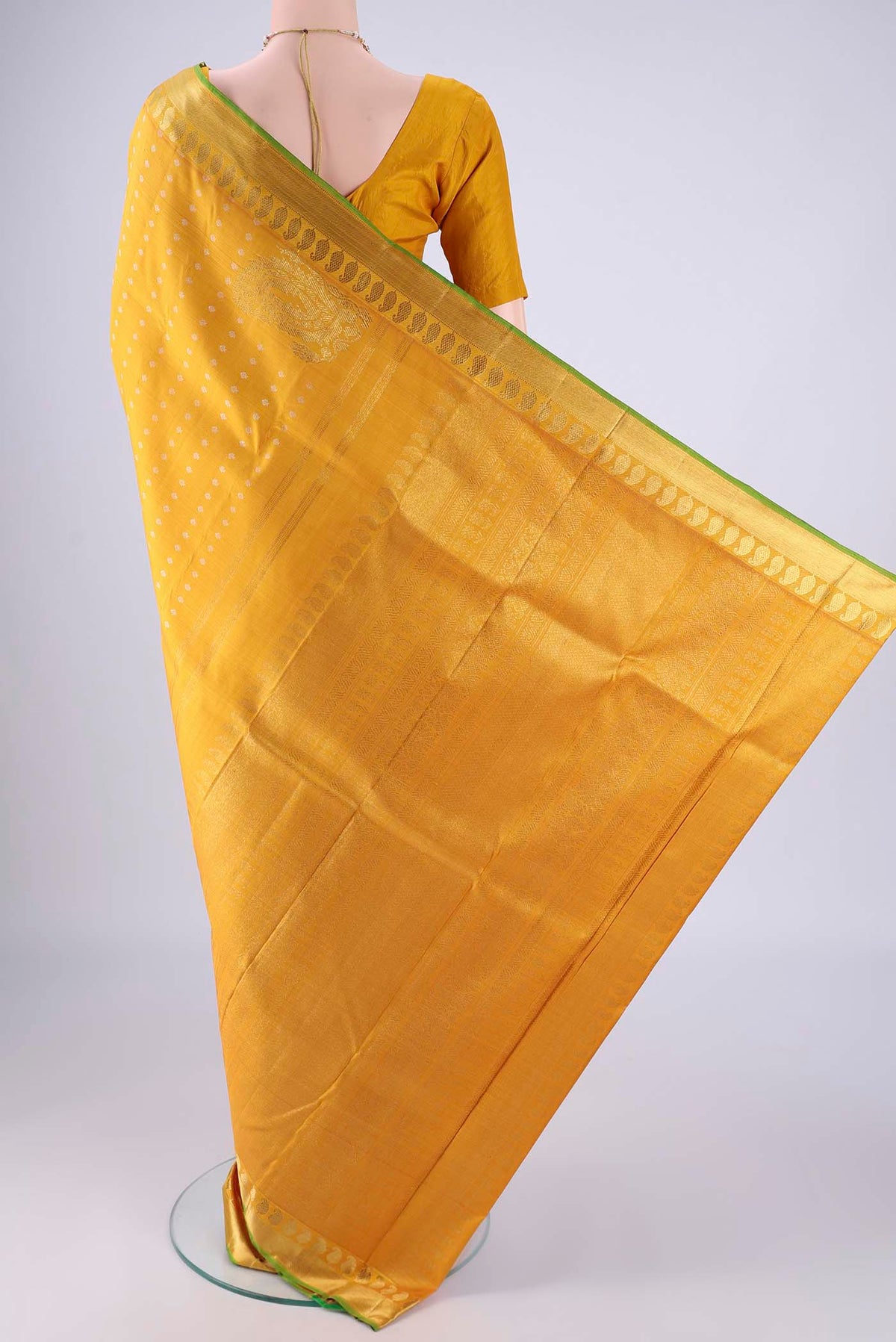Flat view of Mustard Kanjivaram Silk Saree with Zari Butta on the body and Zari Border. 
