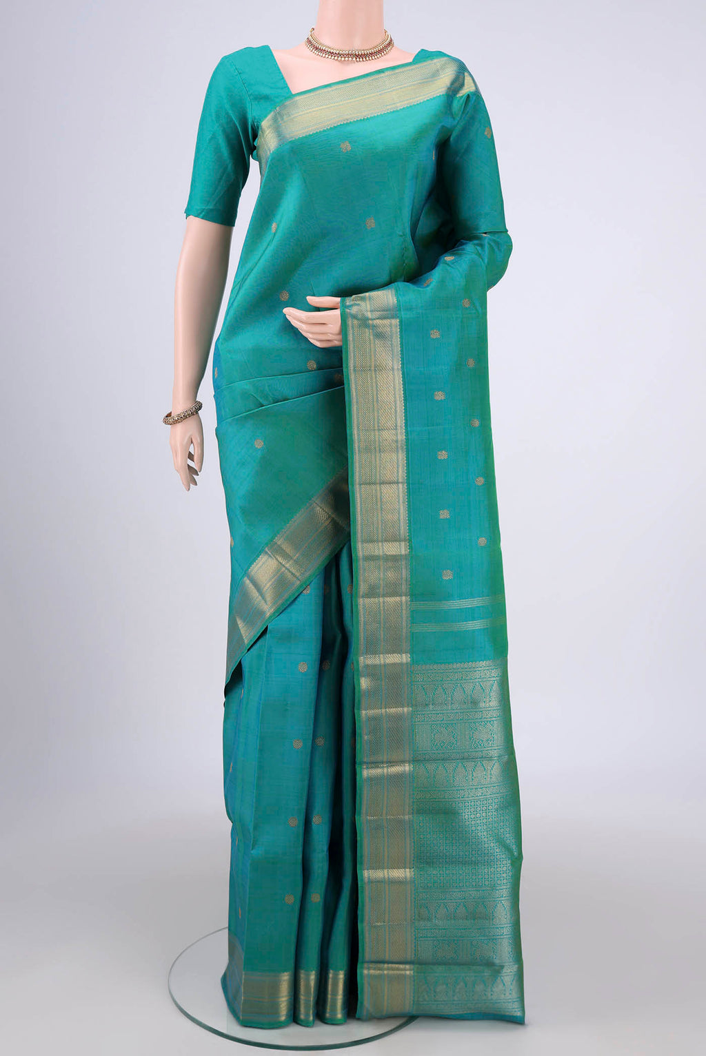 Pure Silk Pure Zari Sea Green Dual Tone Kanjivaram Saree with Zari Butta on the body and Zari Border.  displayed on a mannequin