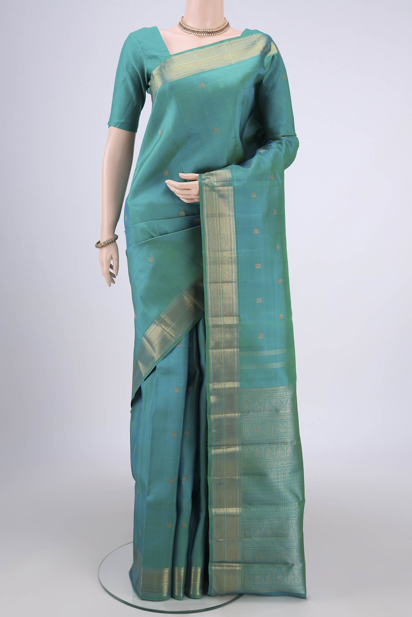Pure Silk Pure Zari Sea Green Dual Tone Kanjivaram Saree with Zari Butta on the body and Zari Border.  displayed on a mannequin