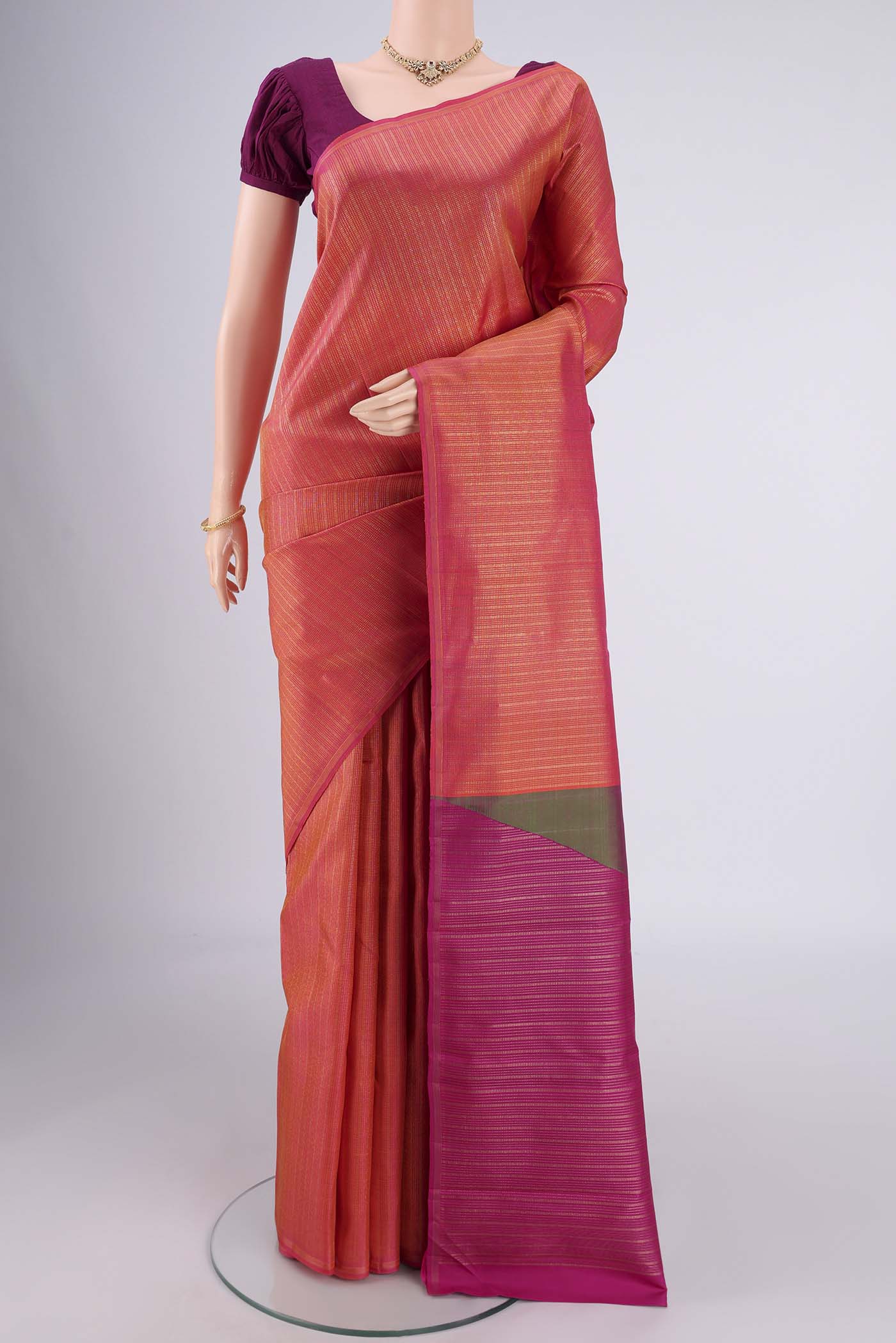 Pure Silk Pure Zari Coral Dual Tone Kanjivaram Saree with Zari Brocade on the body and Without Border.  displayed on a mannequin