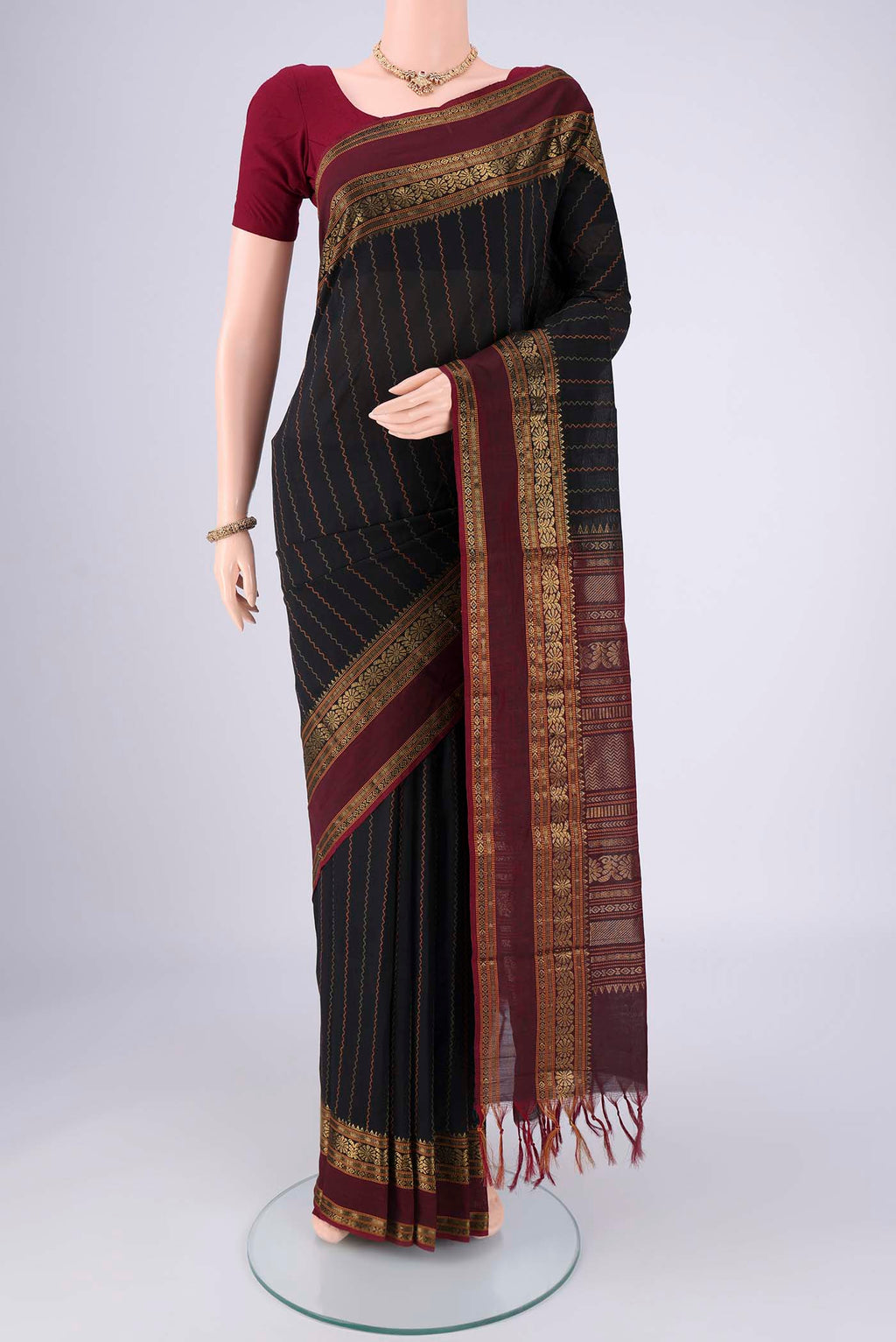 Black Blended Poly Cotton Saree with Veldhari on the body and Zari Border.  displayed on a mannequin