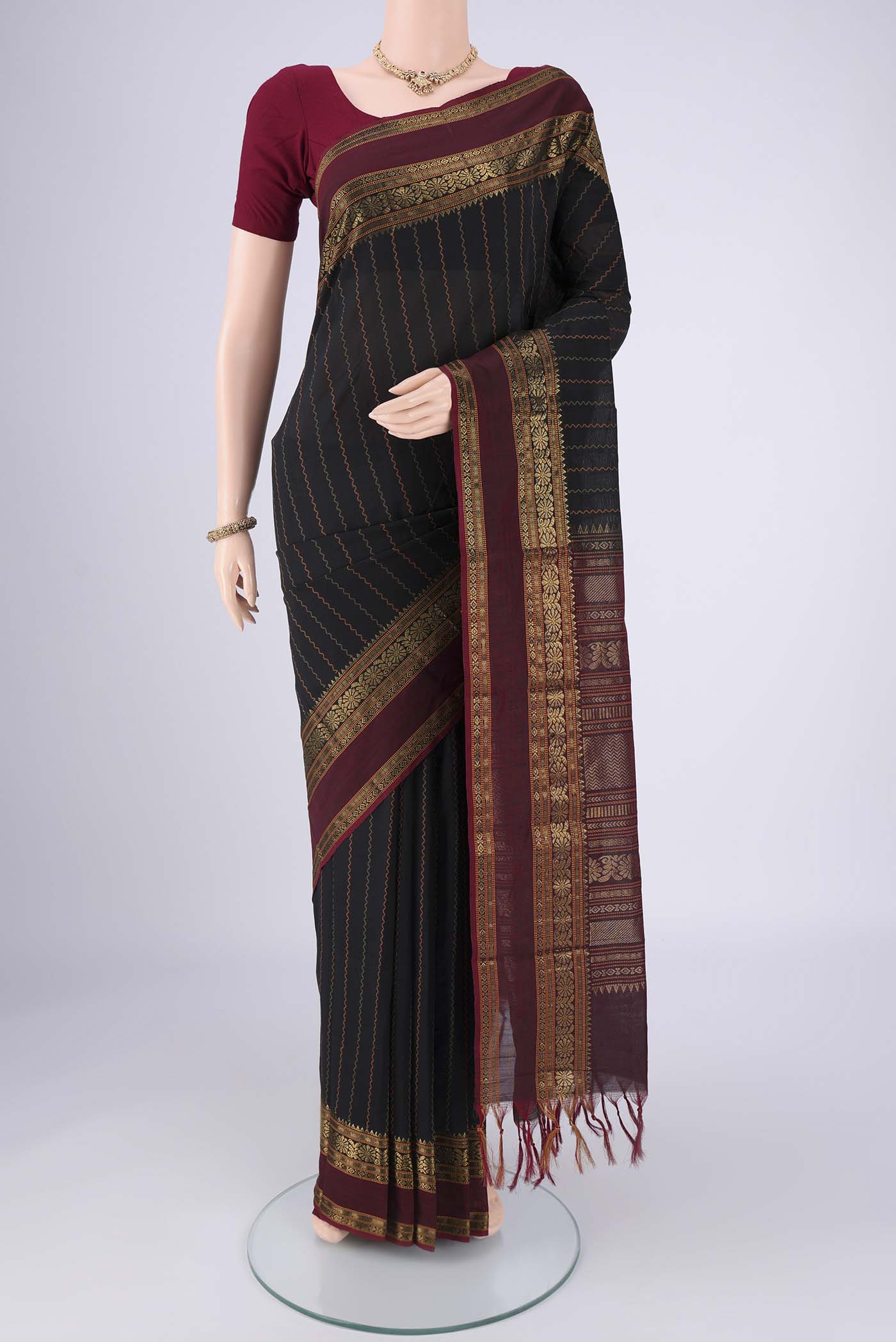 Black Blended Poly Cotton Saree with Veldhari on the body and Zari Border.  displayed on a mannequin