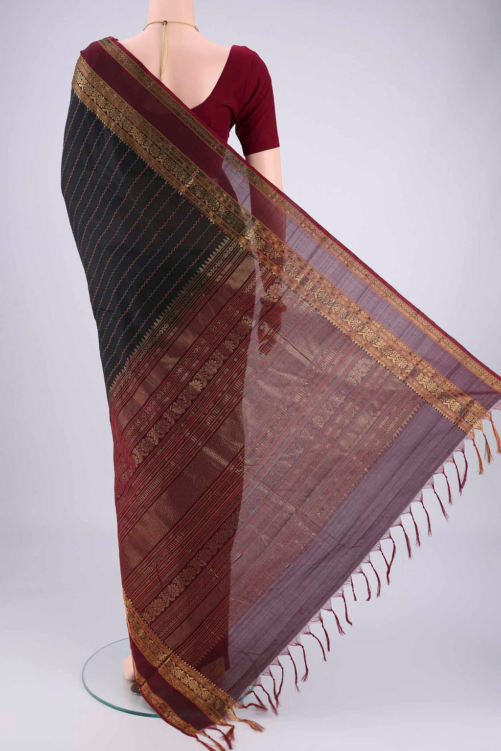 Flat view of Black Blended Poly Cotton Saree with Veldhari on the body and Zari Border. 