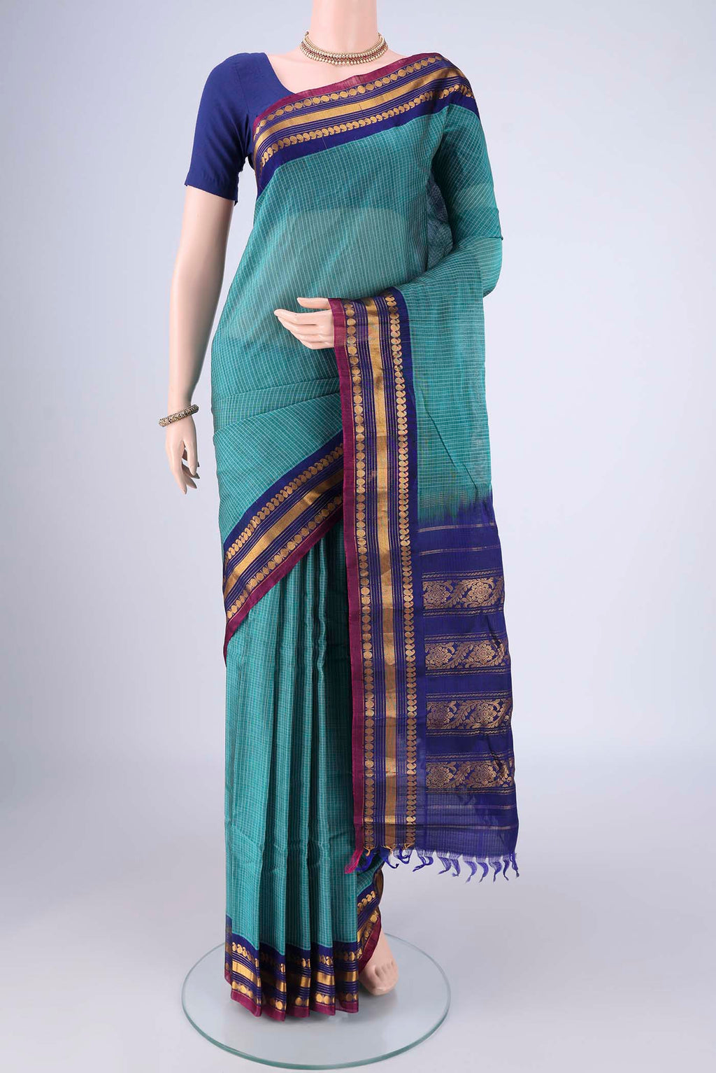 Sea Green Gadwal Silk Cotton Saree with Checked design on the body and Silk Border.  displayed on a mannequin