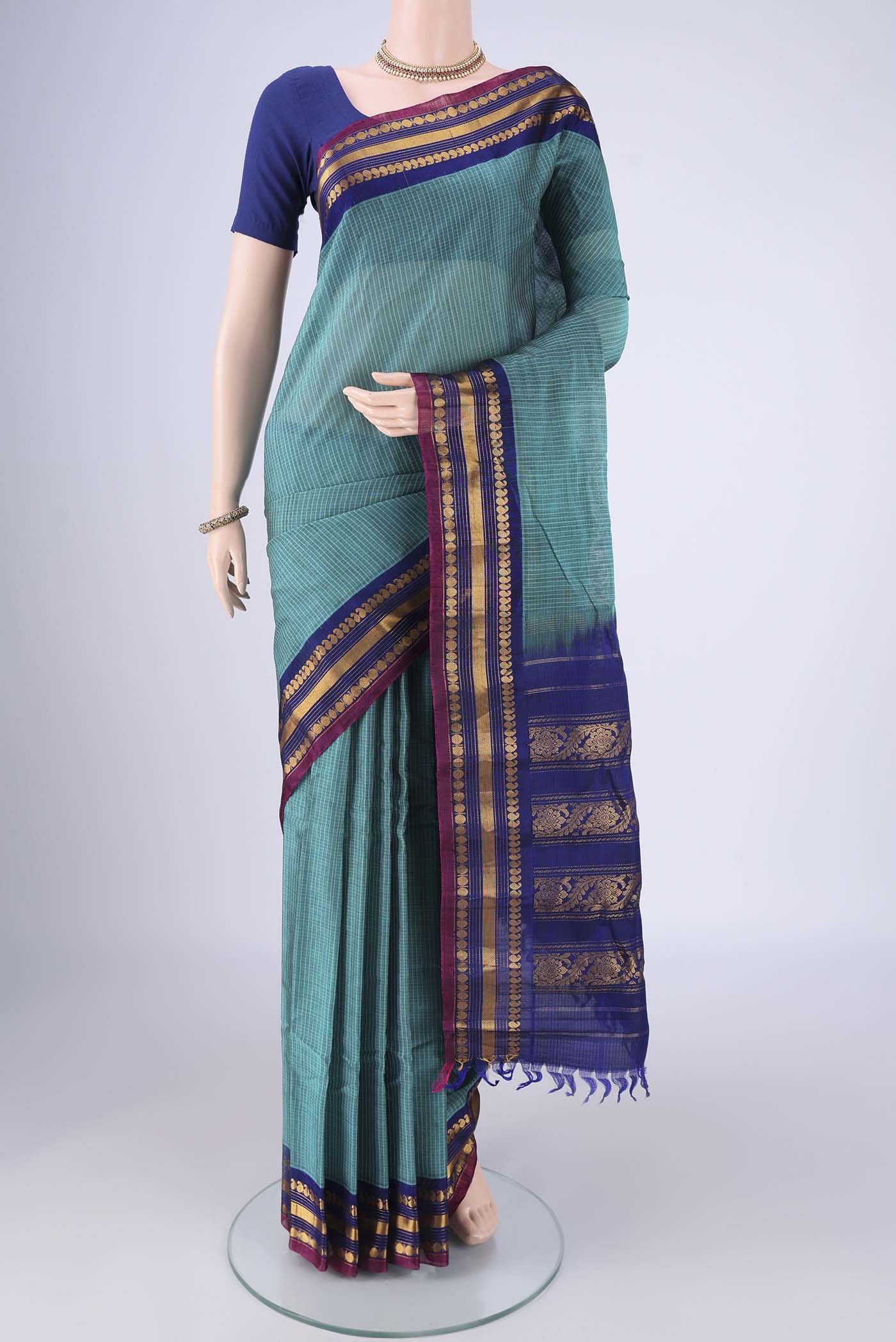 Sea Green Gadwal Silk Cotton Saree with Checked design on the body and Silk Border.  displayed on a mannequin