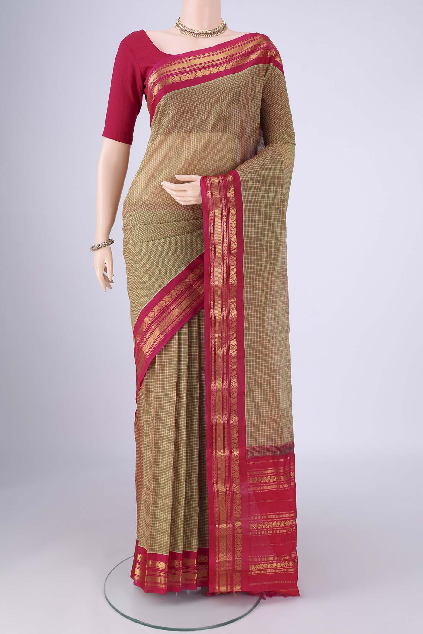 Mehandi Green Gadwal Silk Cotton Saree with Checked design on the body and Silk Border.  displayed on a mannequin