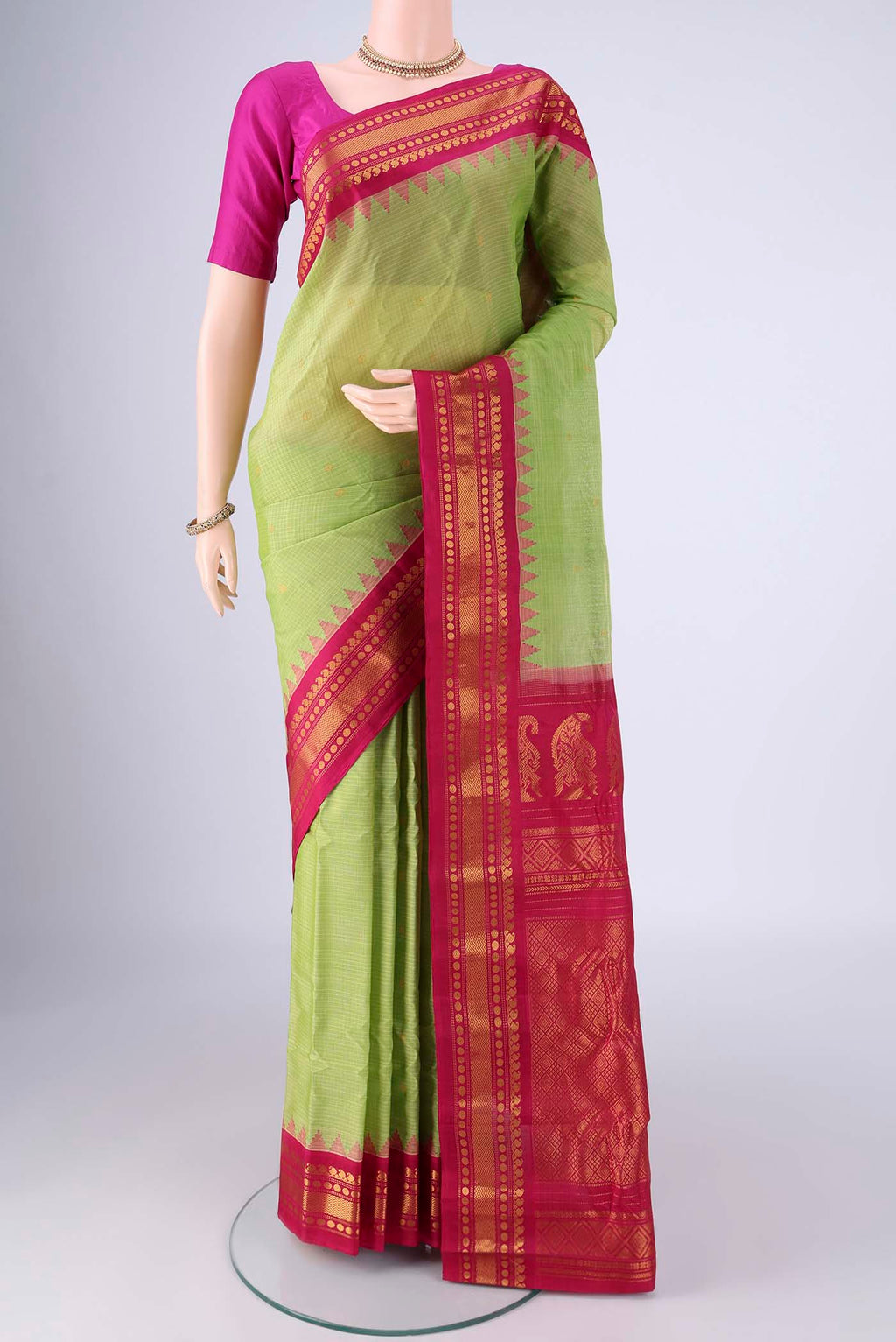 Light Green Gadwal Silk Cotton Saree with Zari Butta on the body and Silk Border.  displayed on a mannequin