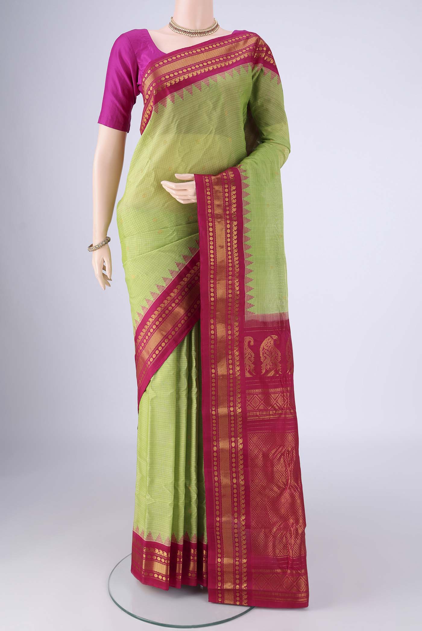 Light Green Gadwal Silk Cotton Saree with Zari Butta on the body and Silk Border.  displayed on a mannequin