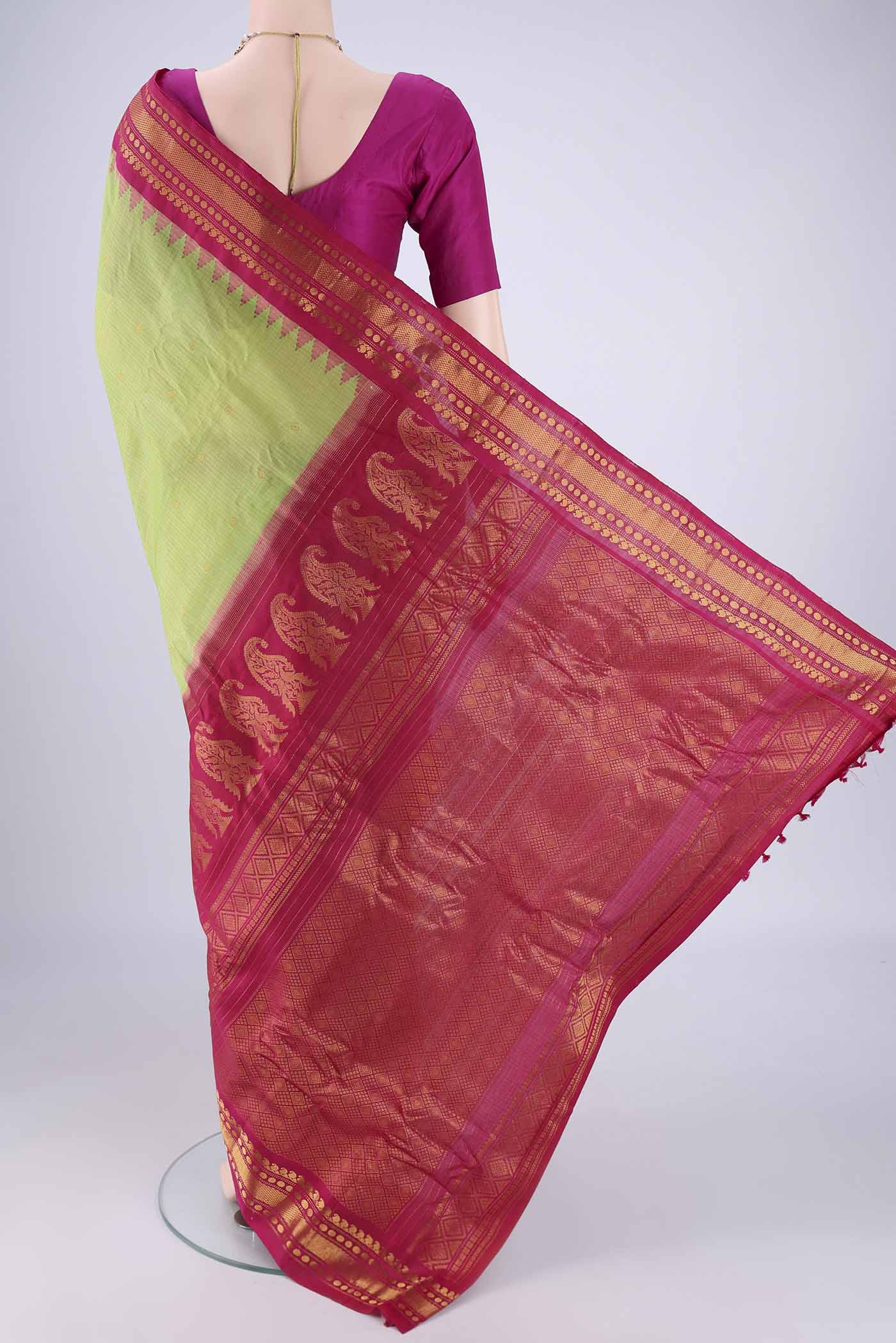 Flat view of Light Green Gadwal Silk Cotton Saree with Zari Butta on the body and Silk Border. 