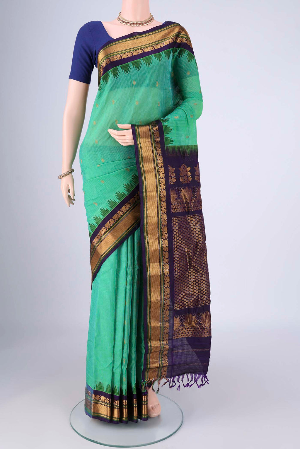 Sea Green Gadwal Silk Cotton Saree with Zari Butta on the body and Silk Border.  displayed on a mannequin