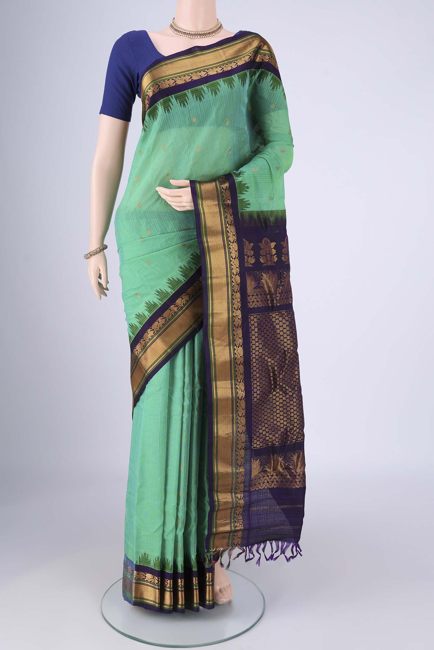 Sea Green Gadwal Silk Cotton Saree with Zari Butta on the body and Silk Border.  displayed on a mannequin