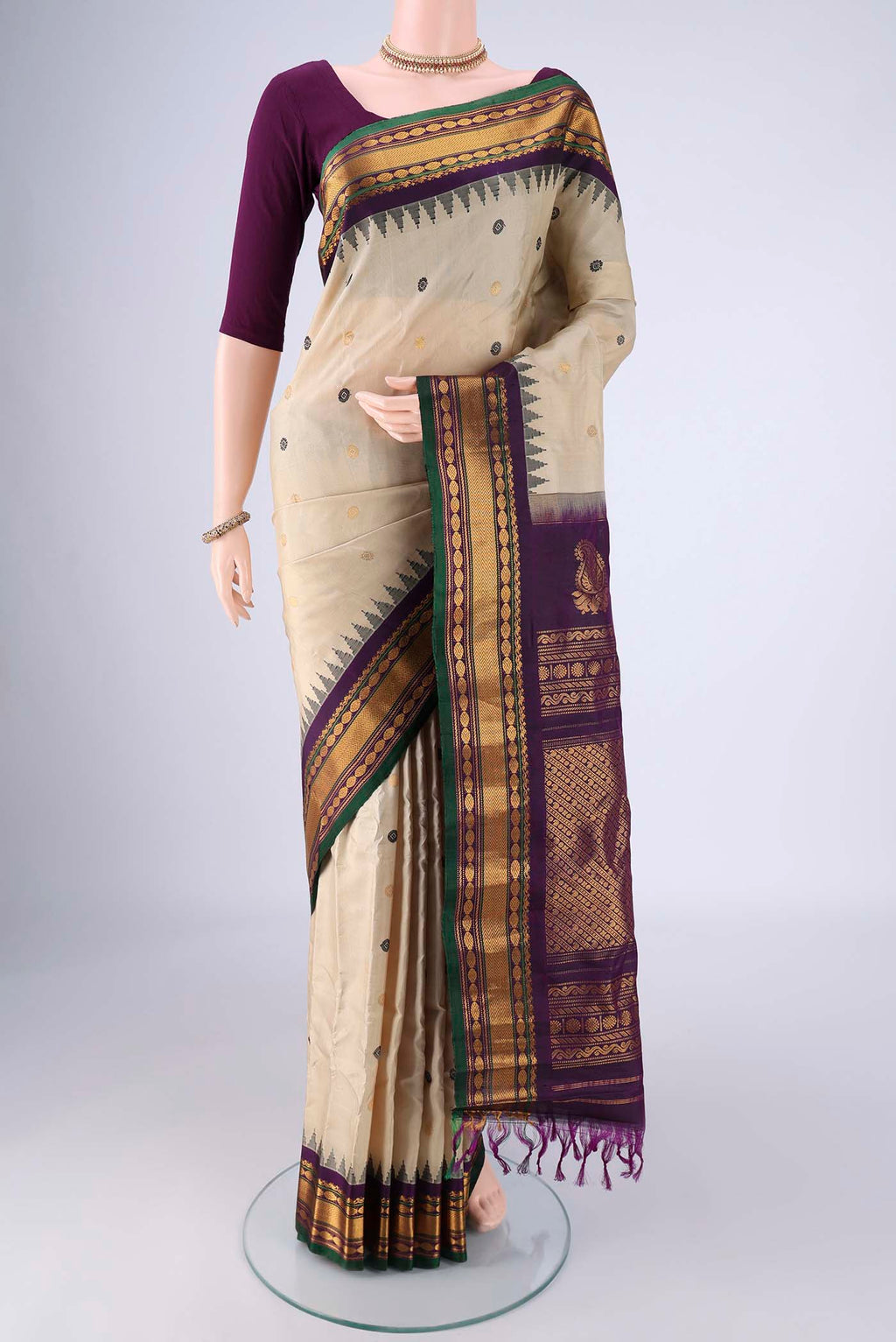 Beige Gadwal Silk Saree with Zari Butta on the body and Zari Border.  displayed on a mannequin
