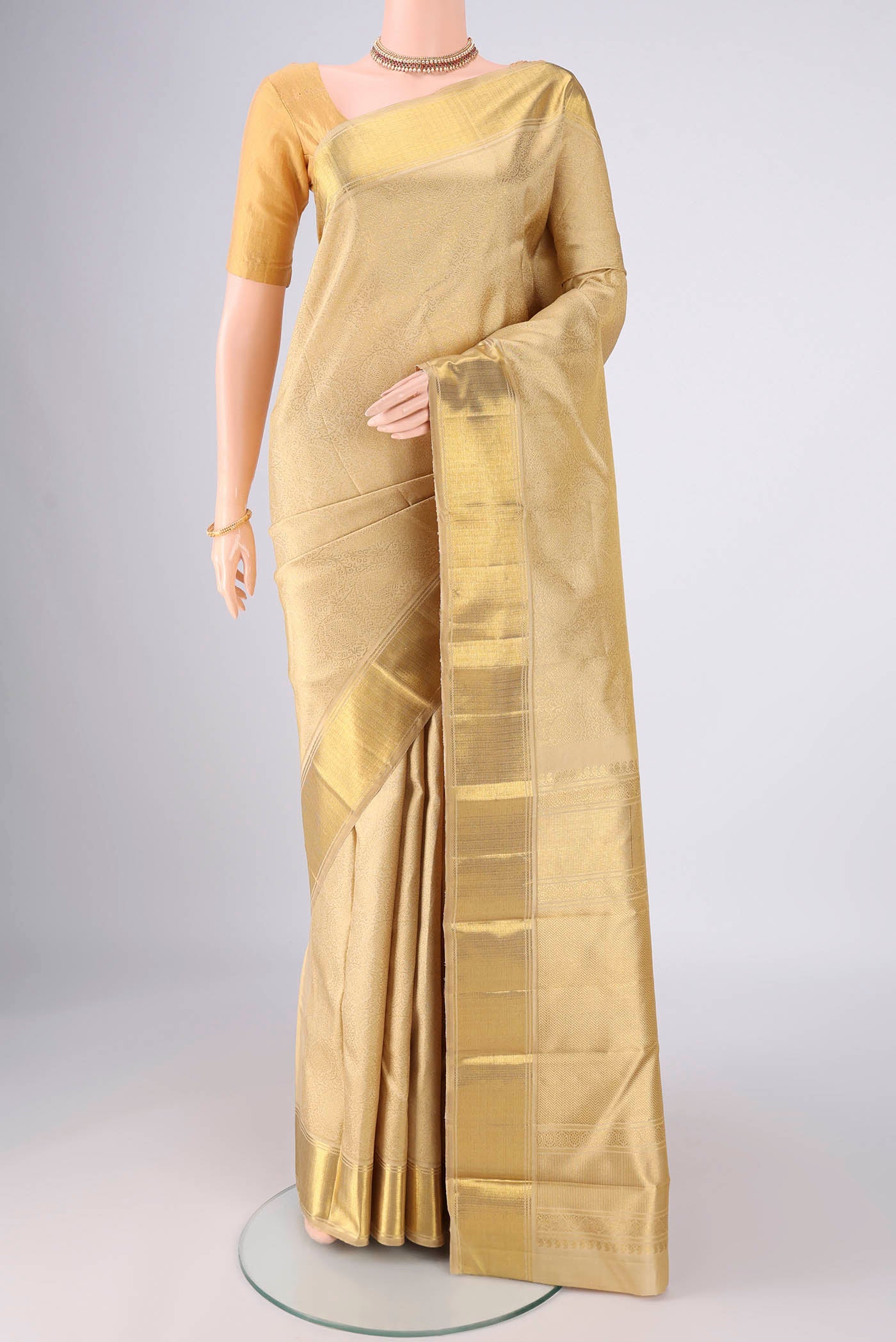 Pure Silk Pure Zari Beige Kanjivaram Saree with Zari Brocade on the body and Zari Border.  displayed on a mannequin
