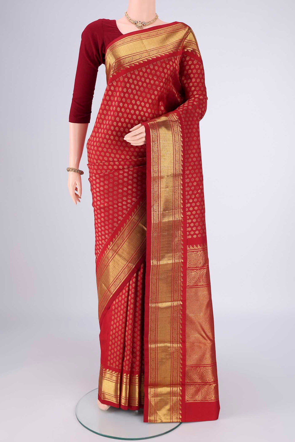 Pure Silk Pure Zari Red Kanjivaram Saree with Zari Brocade on the body and Zari Border.  displayed on a mannequin