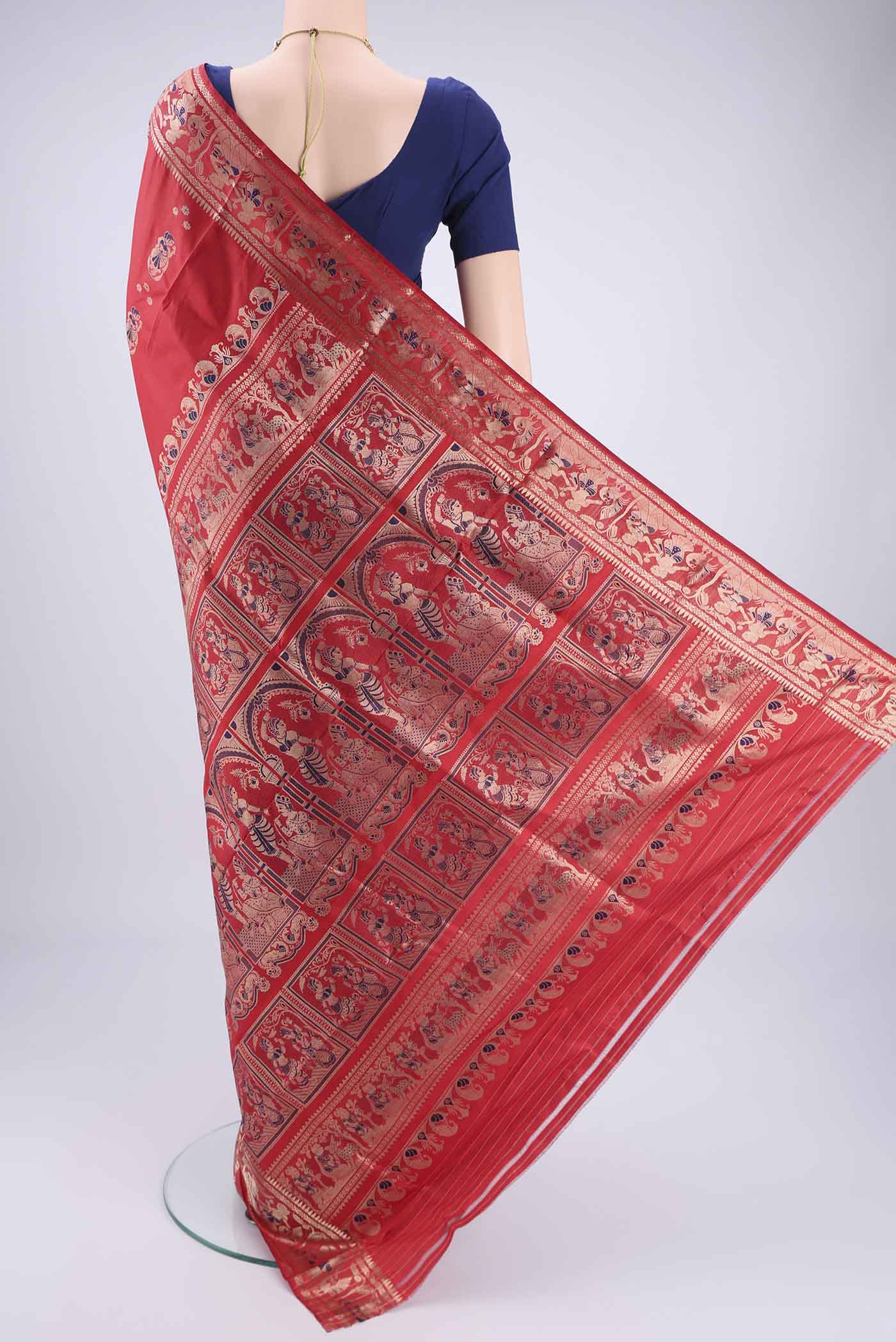 Flat view of Red Baluchari Silk Saree with Zari And Thread Butta on the body and Zari And Thread Border. 