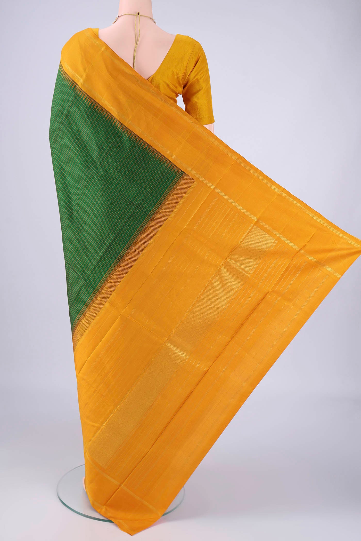 Flat view of Green Kanchipuram Silk Saree with Checked design on the body and Zari Border. 