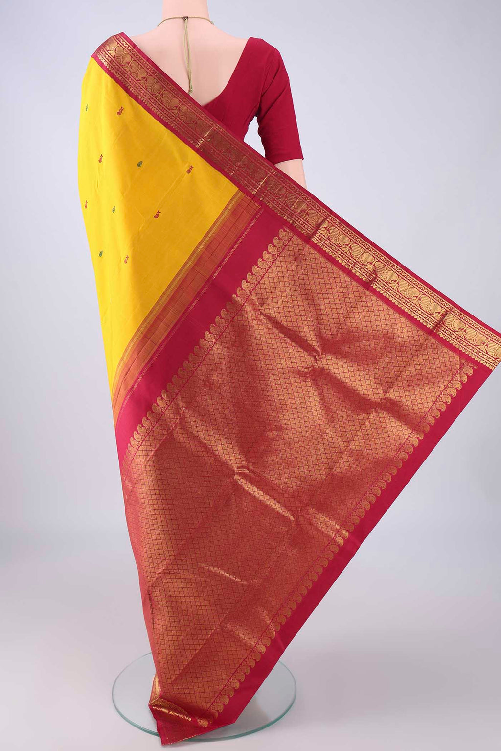 Flat view of Yellow Kanjivaram Silk Saree with Thread Butta on the body and Zari Border. 