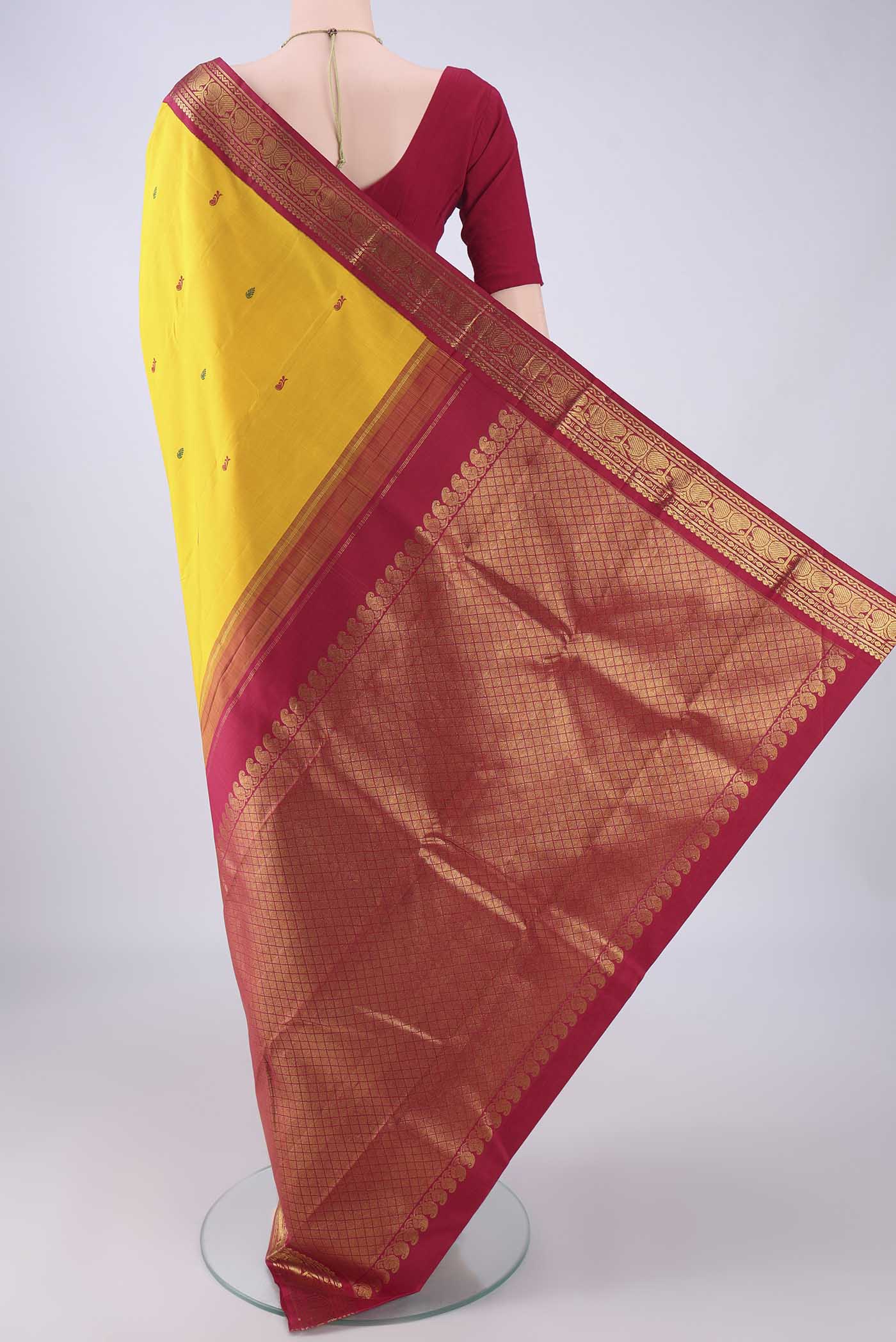 Flat view of Yellow Kanjivaram Silk Saree with Thread Butta on the body and Zari Border. 