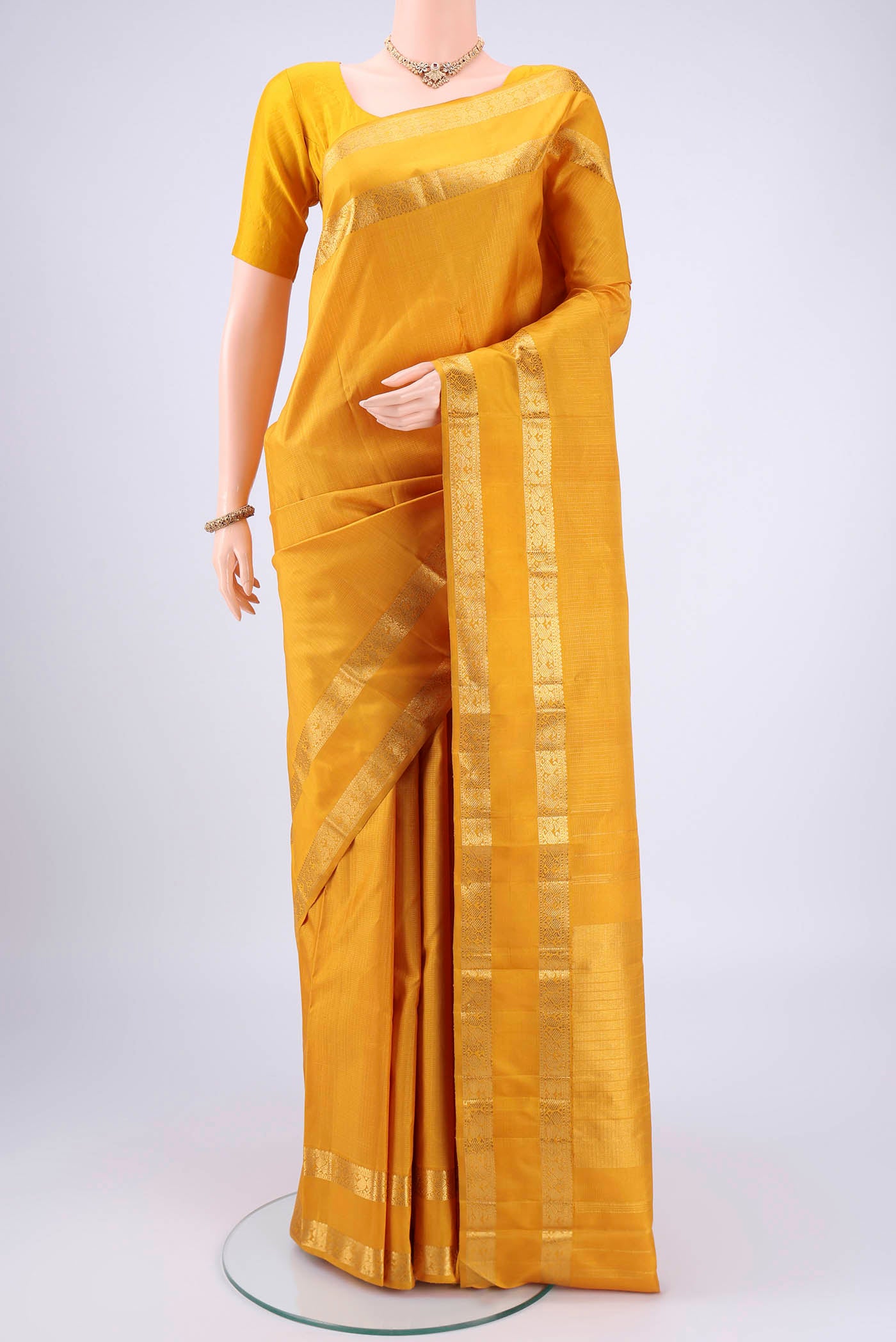 Mustard Coimbatore Silk Cotton Saree with Checked design on the body and Zari Border.  displayed on a mannequin