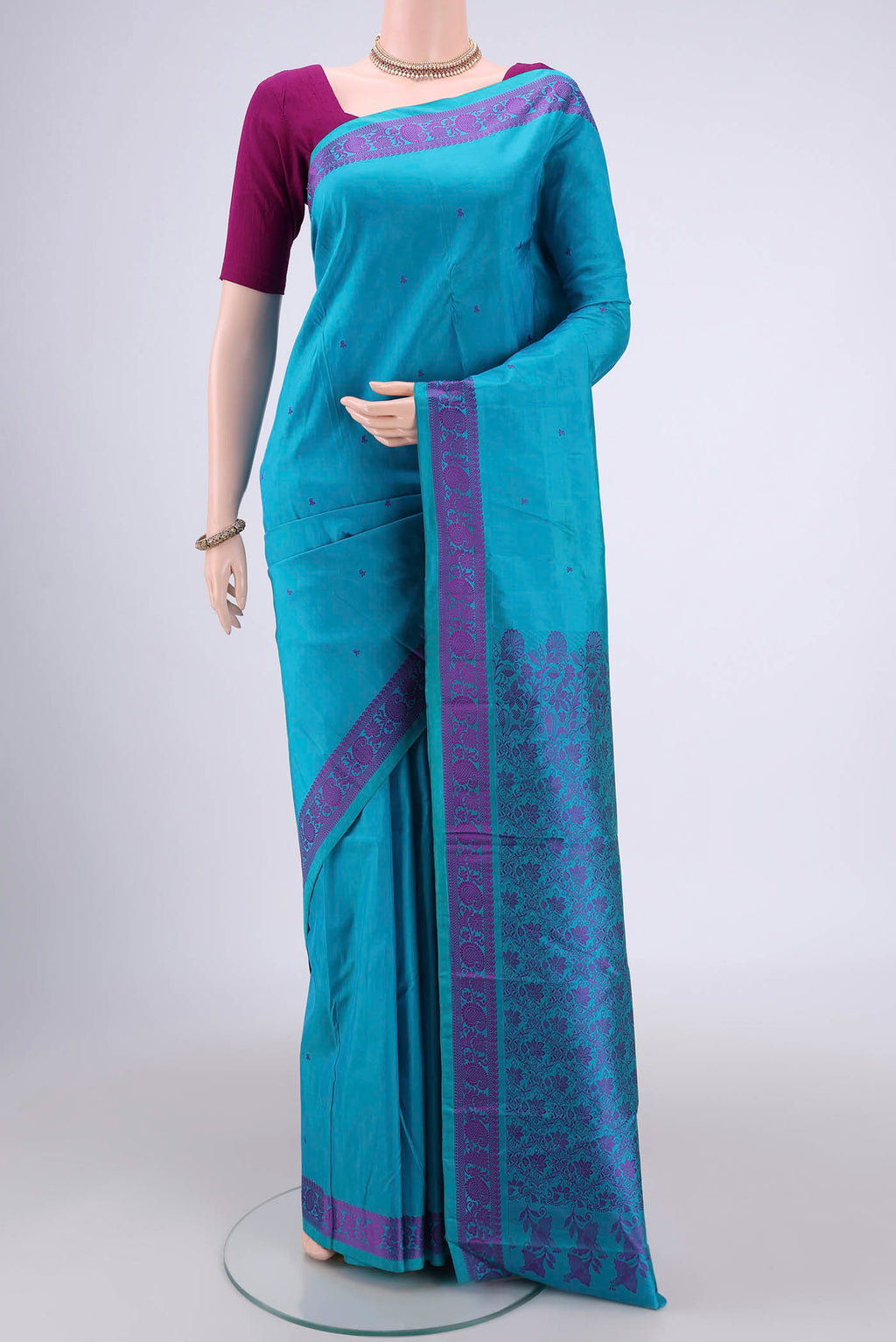 Blue Kanchipuram Silk Saree with Thread Butta on the body and Thread Border.  displayed on a mannequin