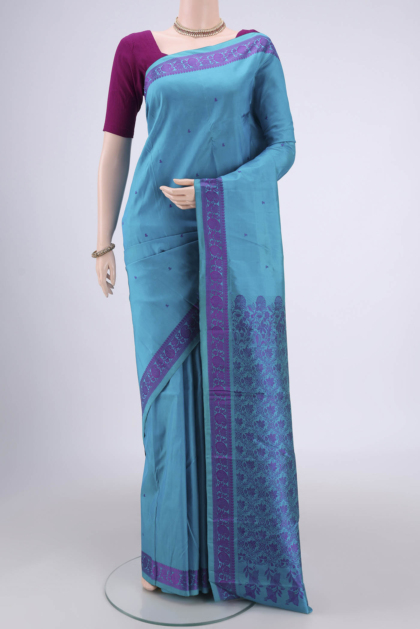 Blue Kanchipuram Silk Saree with Thread Butta on the body and Thread Border.  displayed on a mannequin