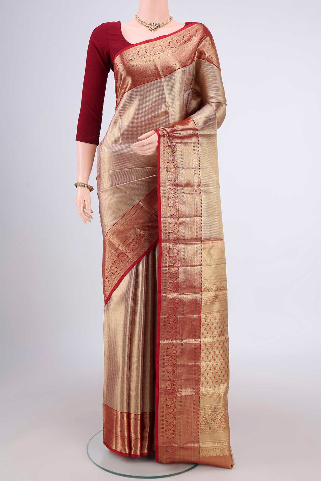 Gold with maroom Dual Tone Kanjivaram Silk Saree with Zari Brocade on the body and Zari Border.  displayed on a mannequin