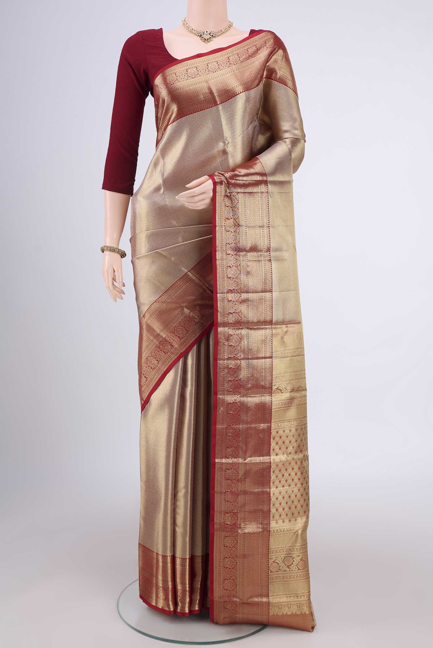 Gold with maroom Dual Tone Kanjivaram Silk Saree with Zari Brocade on the body and Zari Border.  displayed on a mannequin