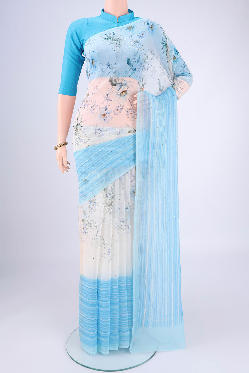 White Mysore Chiffon Saree with Floral Print on the body and Sequin Border.  displayed on a mannequin